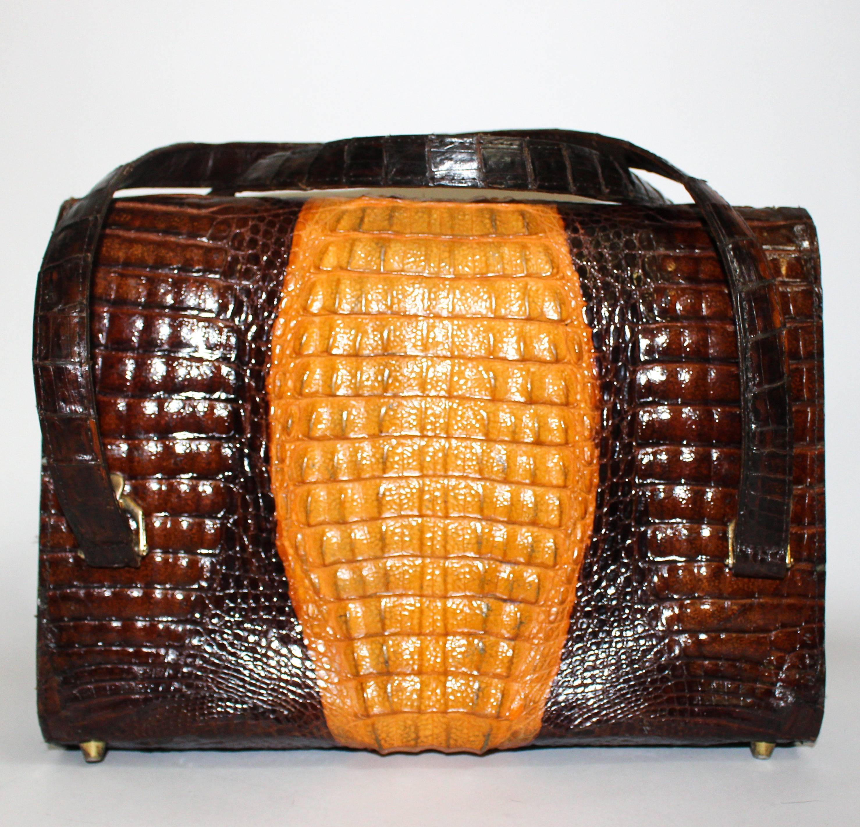 1970s bicolour alligator satchel. Gold-toned hardware. Has metal feet. Leather lining. Three full compartments plus three additional pockets.

Strap length: 26