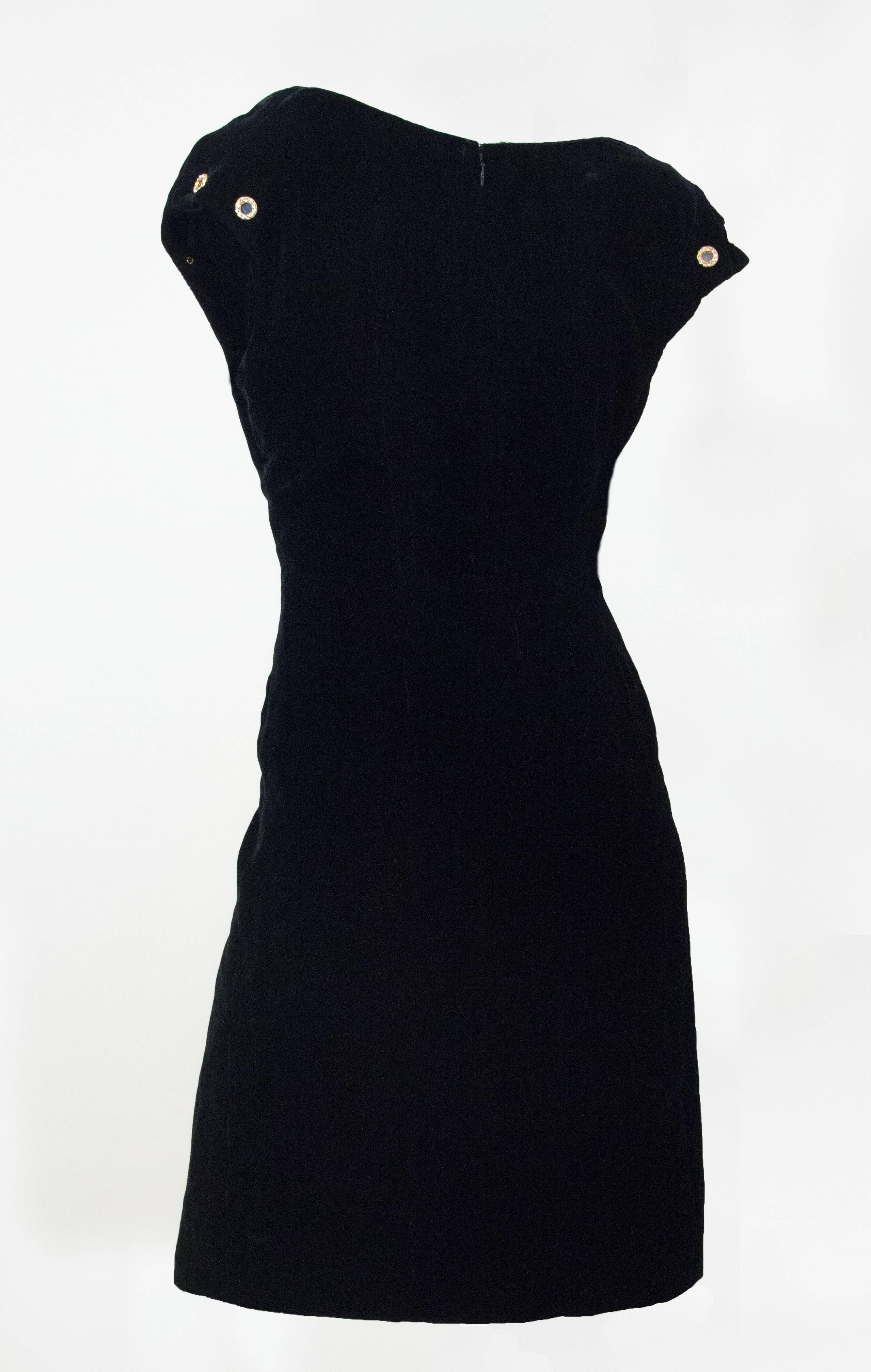 90s Christian Lacroix velvet sheath dress. Gold tone rhinestone encrusted grommets on cap sleeves. One inset pocket on left front. Fully lined. Zips up the back. 
