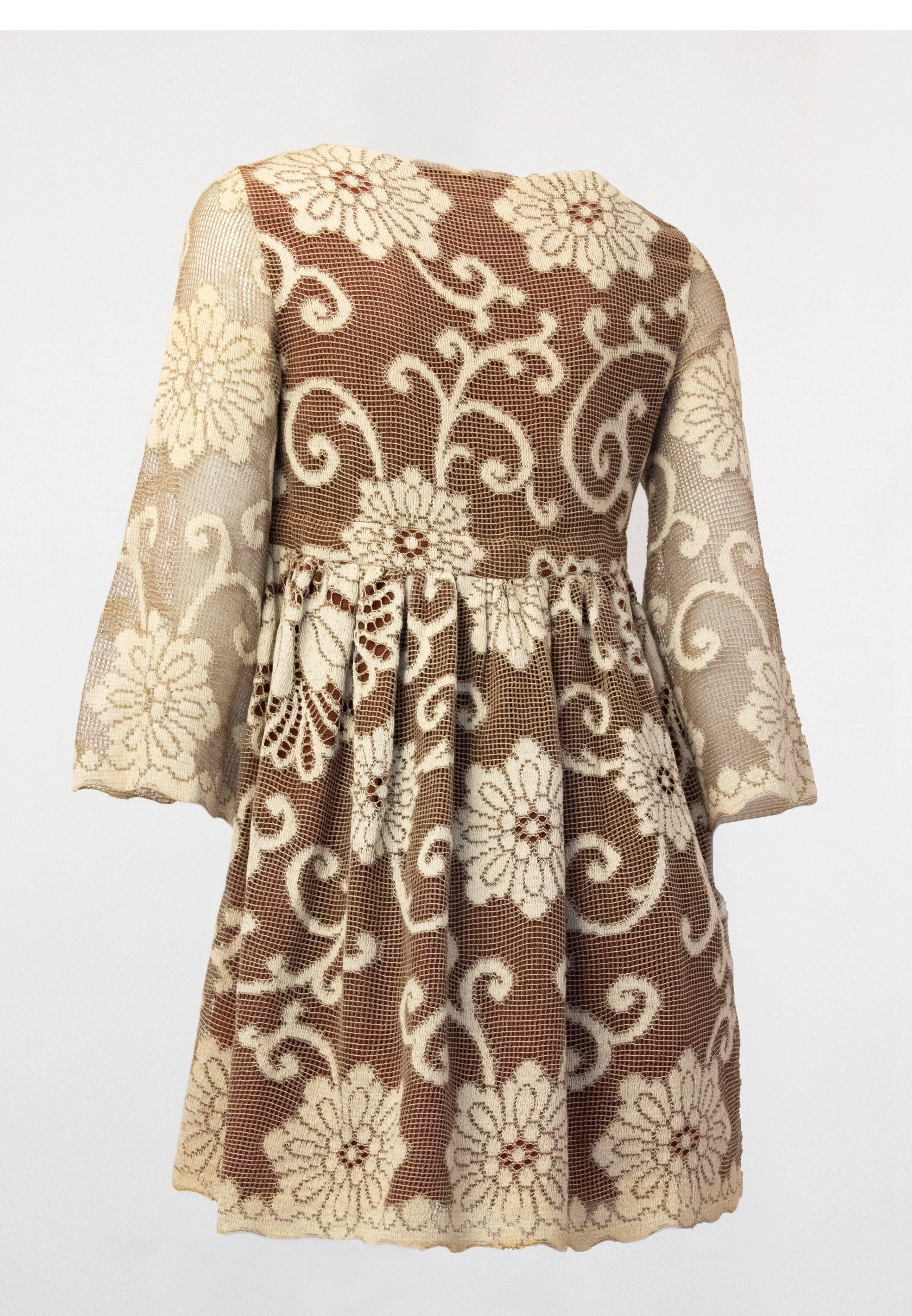 60s mini babydoll dress in cream lace over brown crepe. Empire waist tie. 

 