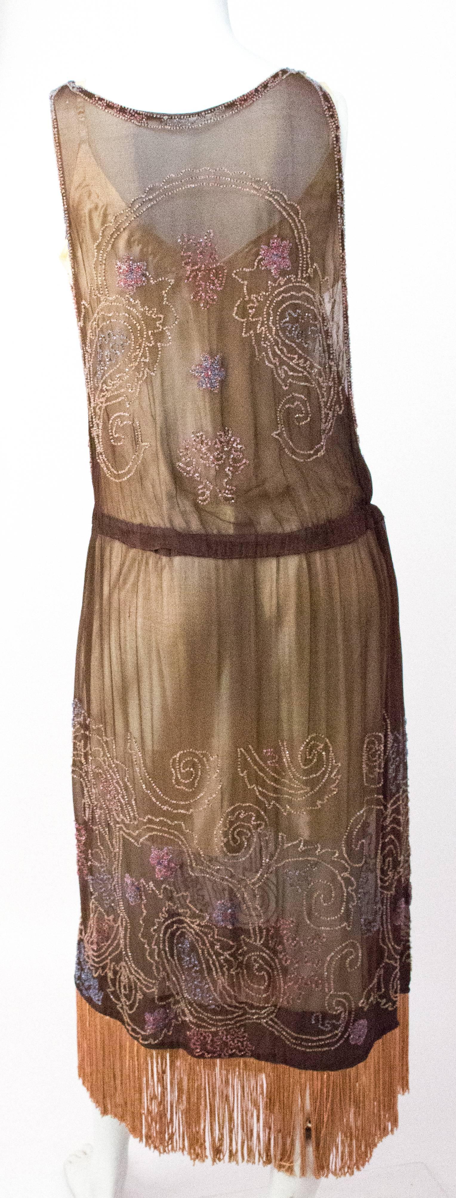 20s Brown Chiffon Dress with Peach Beading & Fringe. Elastic in waist. Unlined. 