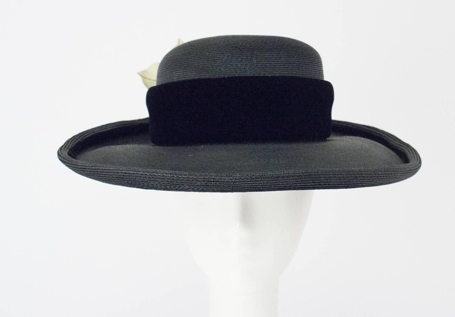 80s Christian Dior Black Straw Wide Brim Hat with Velvet Trim and Red Rose. Leaves of Rose have wire in stem for shaping. Rose has some velvet petals. Grosgrain interior hat band. 

Measurements:
Interior circumference: 20 3/4 inches
Brim width: