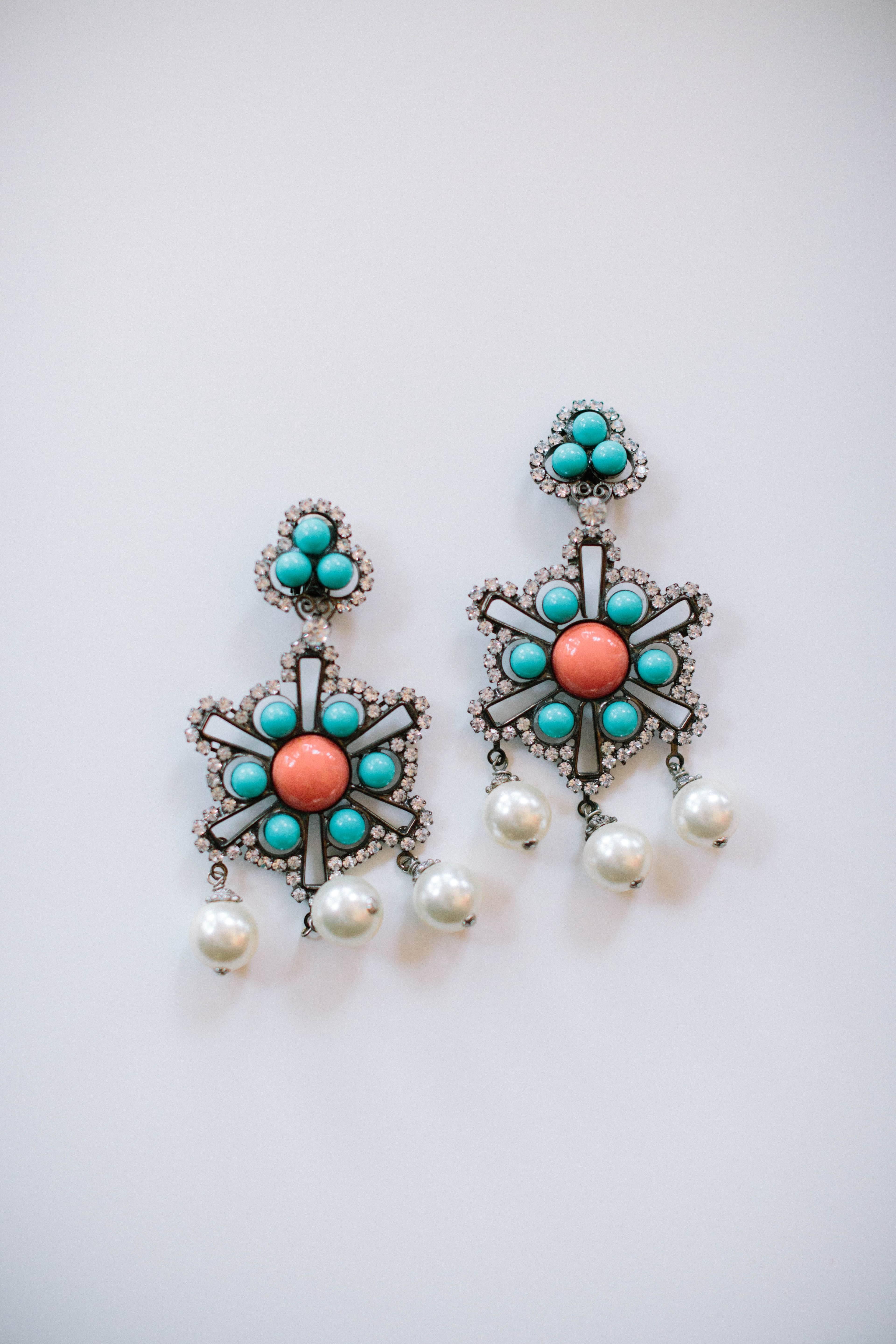 Turn heads this season with these gorgeous gunmetal Lawrence Vrba Chandelier Earrings. This stunning pair features rhinestones, coral and turquoise beads and faux pearls. These clip-on earrings include a signature at the back and measure at 5