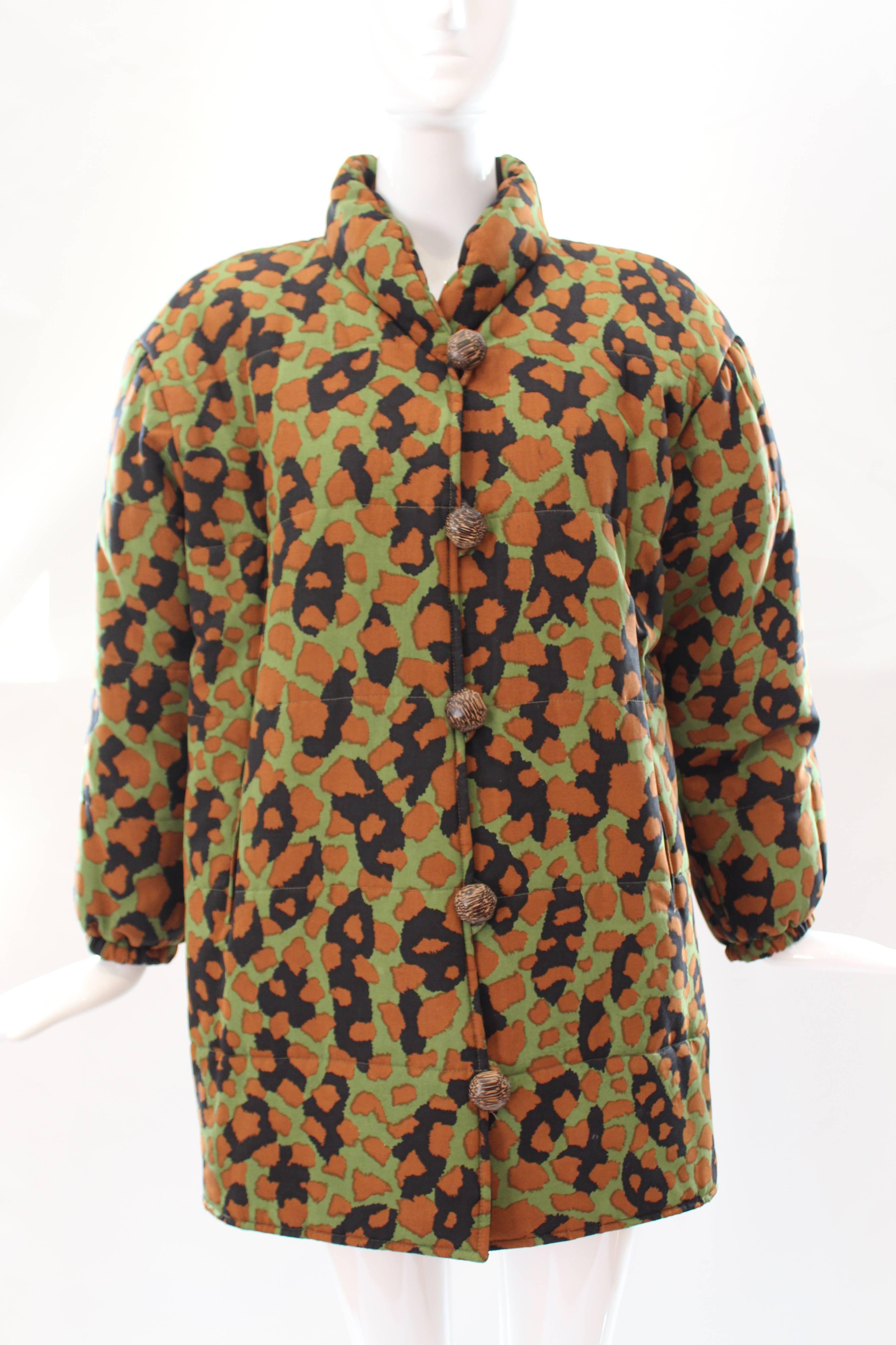 This YSL puffer coat combines modern style with a timeless shape. Stay warm in style in this camouflage puffer coat! 

Fits straight up and down. Puff sleeves. Elastic hem at the bottom of the sleeves. Camouflage print. Stand up collar. 5 wooden