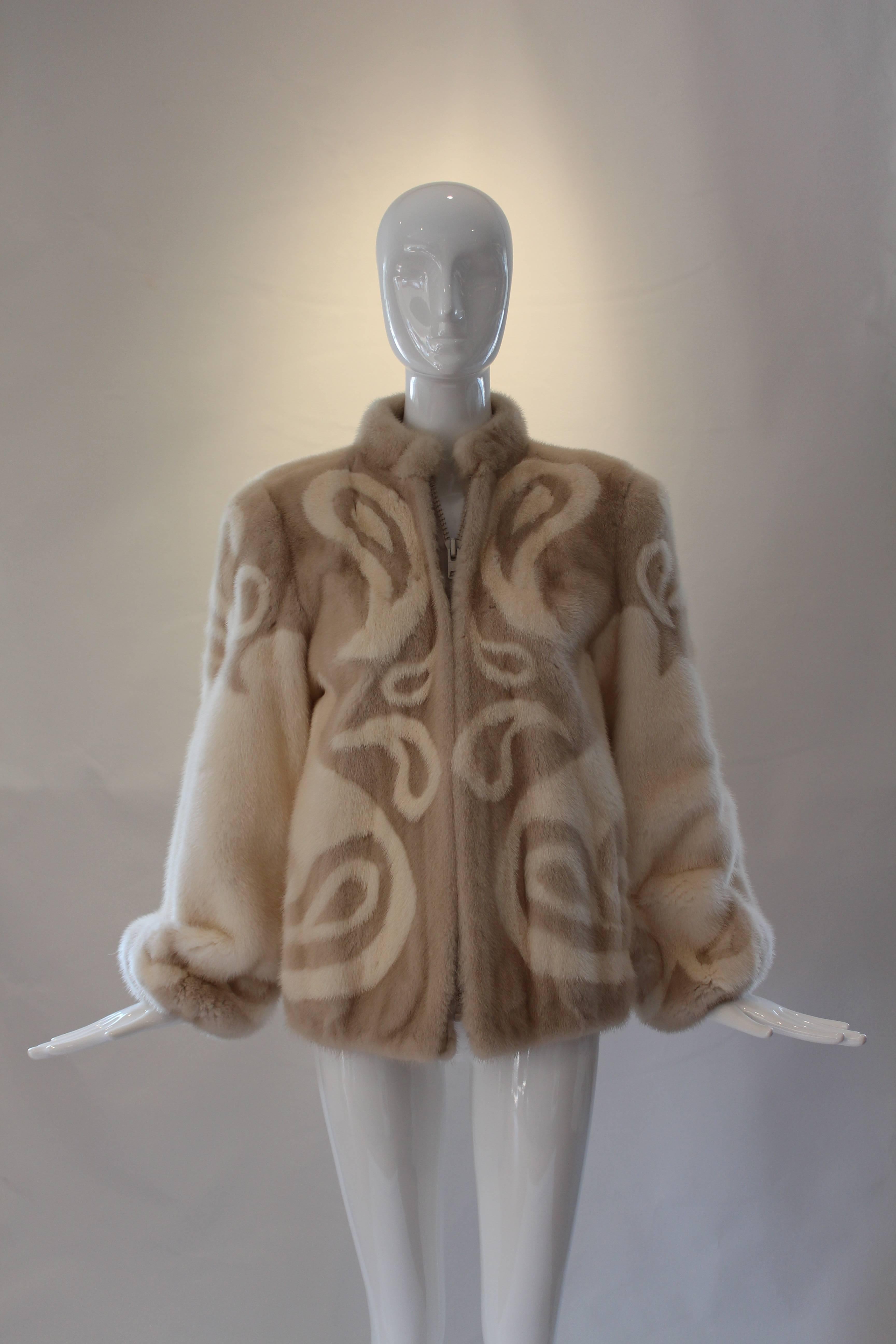 This amazing Adolfo zip front jacket is fashioned from two shades of mink fur forming a paisley print.  Full sleeves and elastic jacket bottom provide lots of shape.  The front zipper is both sturdy and substantial - true Adolfo quality.