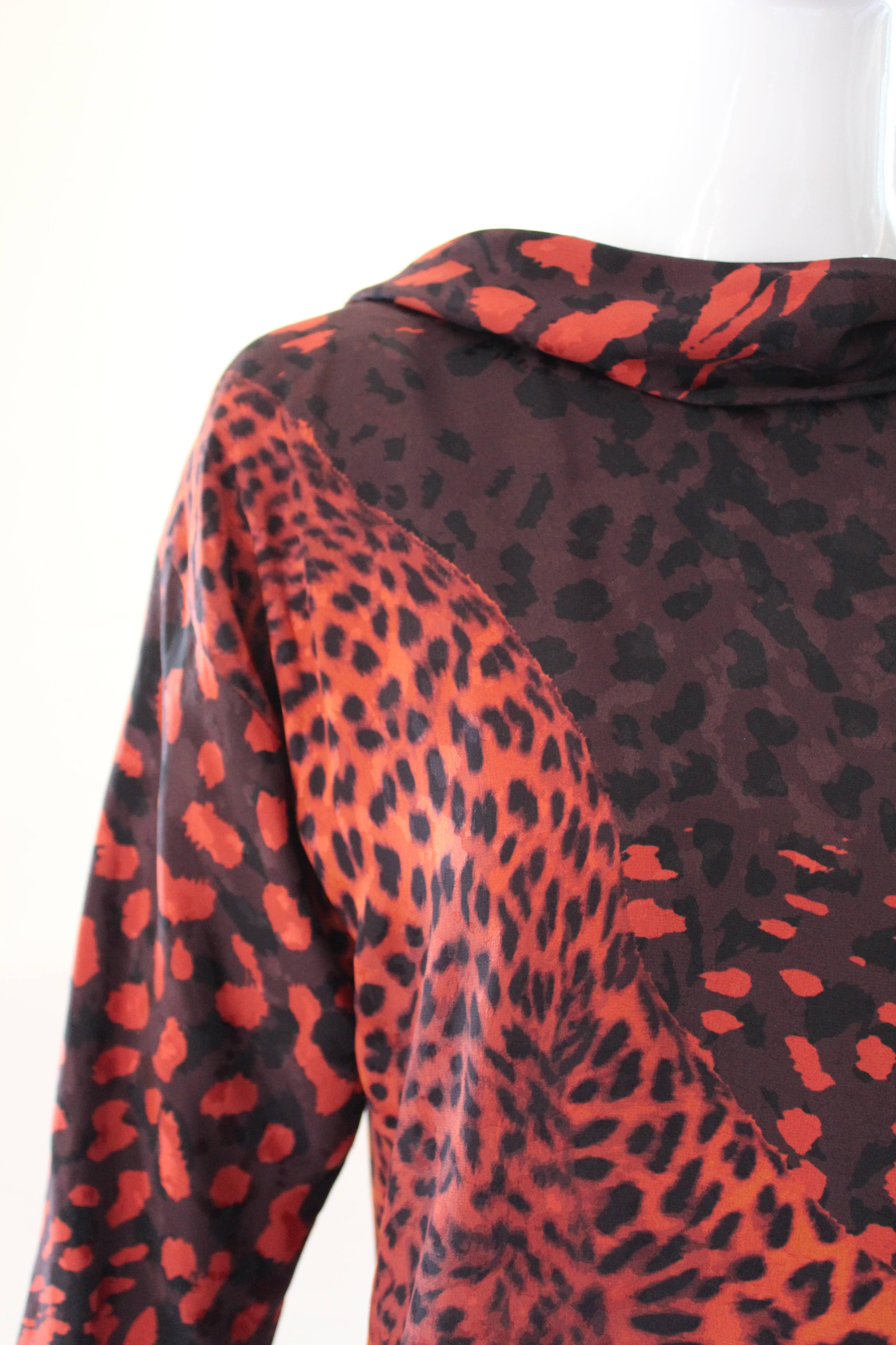 Amazing leopard print silk dress with tiger face on front and back. Fashioned from shades of brick red, orange, brown and black silk and entirely lined.  The lovely draped neckline drops down lower in the back.  Hemline is gathered in the back with