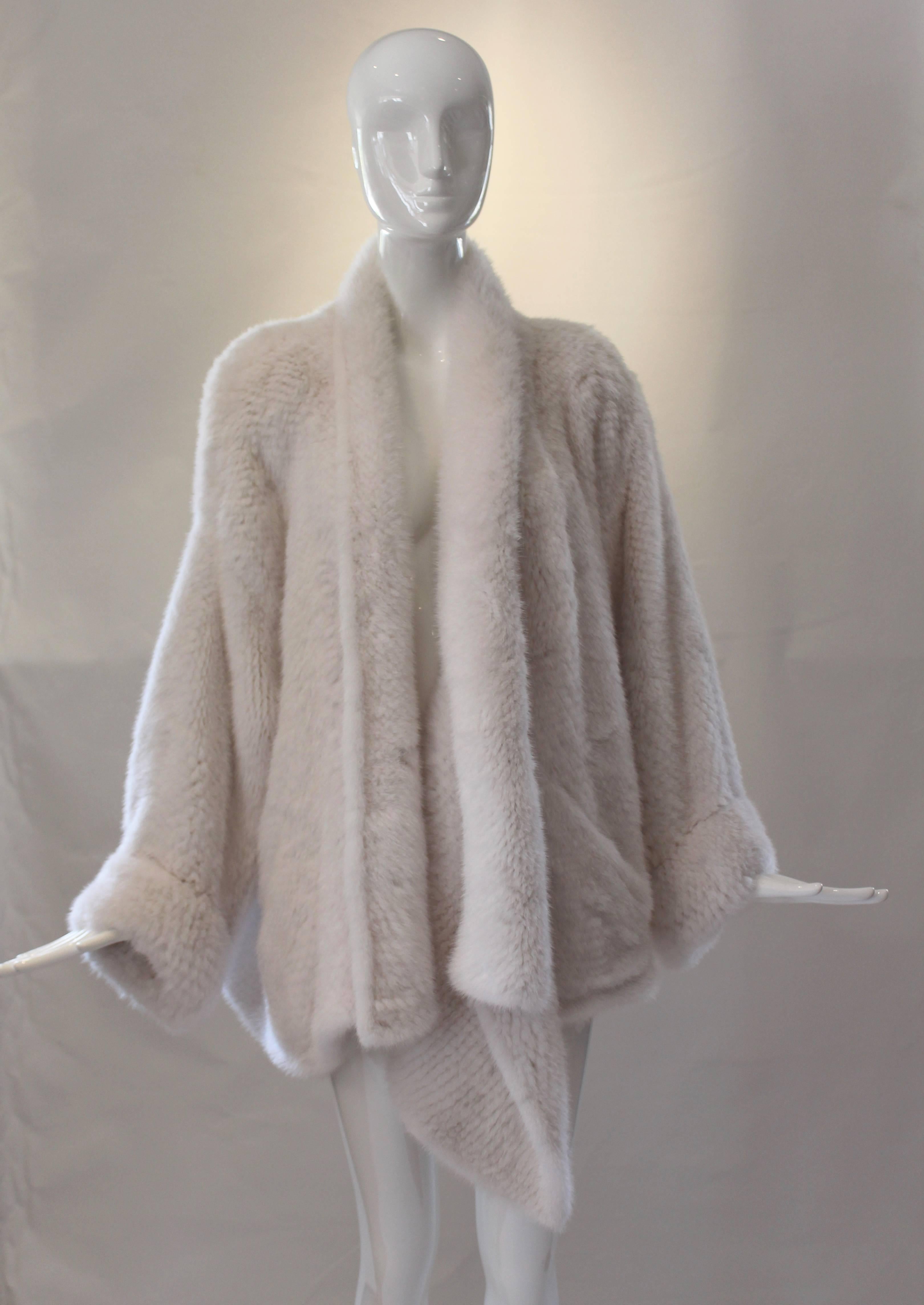 This amazing Dior crochet mink jacket is pristine white.  It's drapey construction adds to its high fashion vibe.  Crossover front to single button if you wish or leave open and drapey.  It is super soft and luxe.  Quite a rare find.