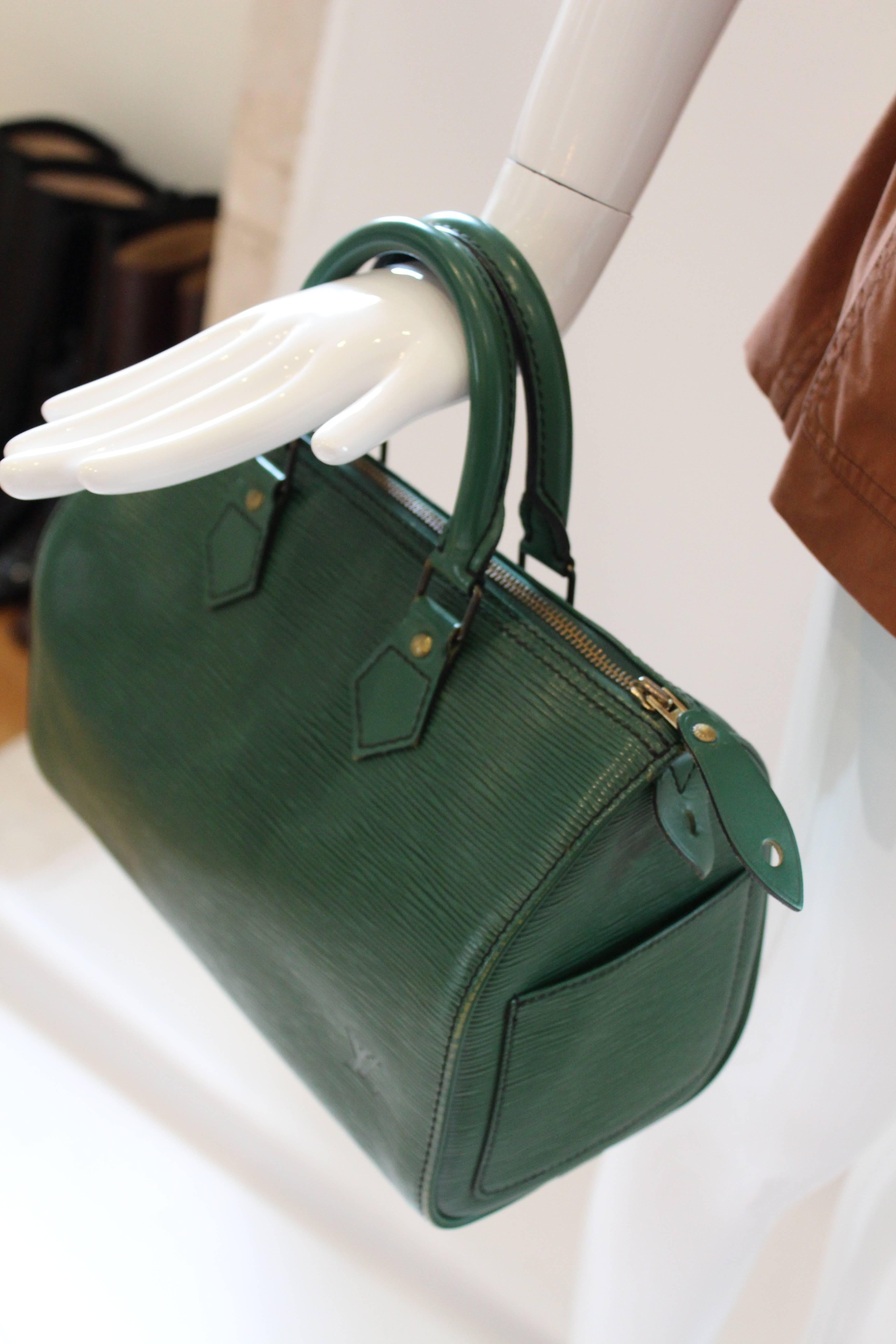 
This darling LV Epi Speedy is in perfect condition and large enough to hold all of your belongings.  It's Epi leather is a rich emerald color and bag features top handles and zip, inside and outside pockets.  The fine craftsmanship you have come