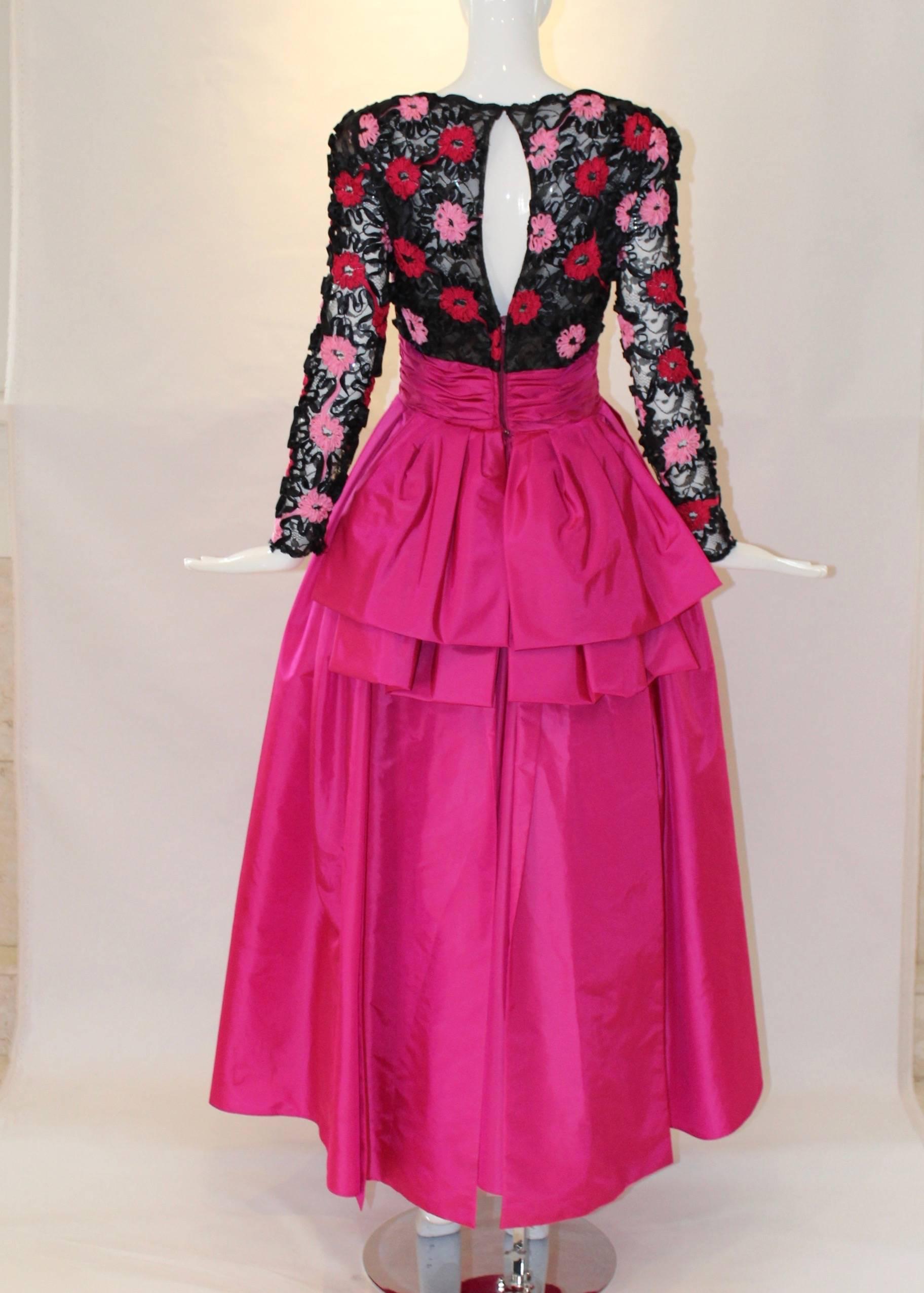 This head-turning 1980s Victor Costa ball gown has a sheer ribbon weave floral bodice and is fitted at the waist. With hidden shoulder pads, a bright pink full taffeta skirt and a bow back details, this gown is ready for dancing! 
59” from shoulder