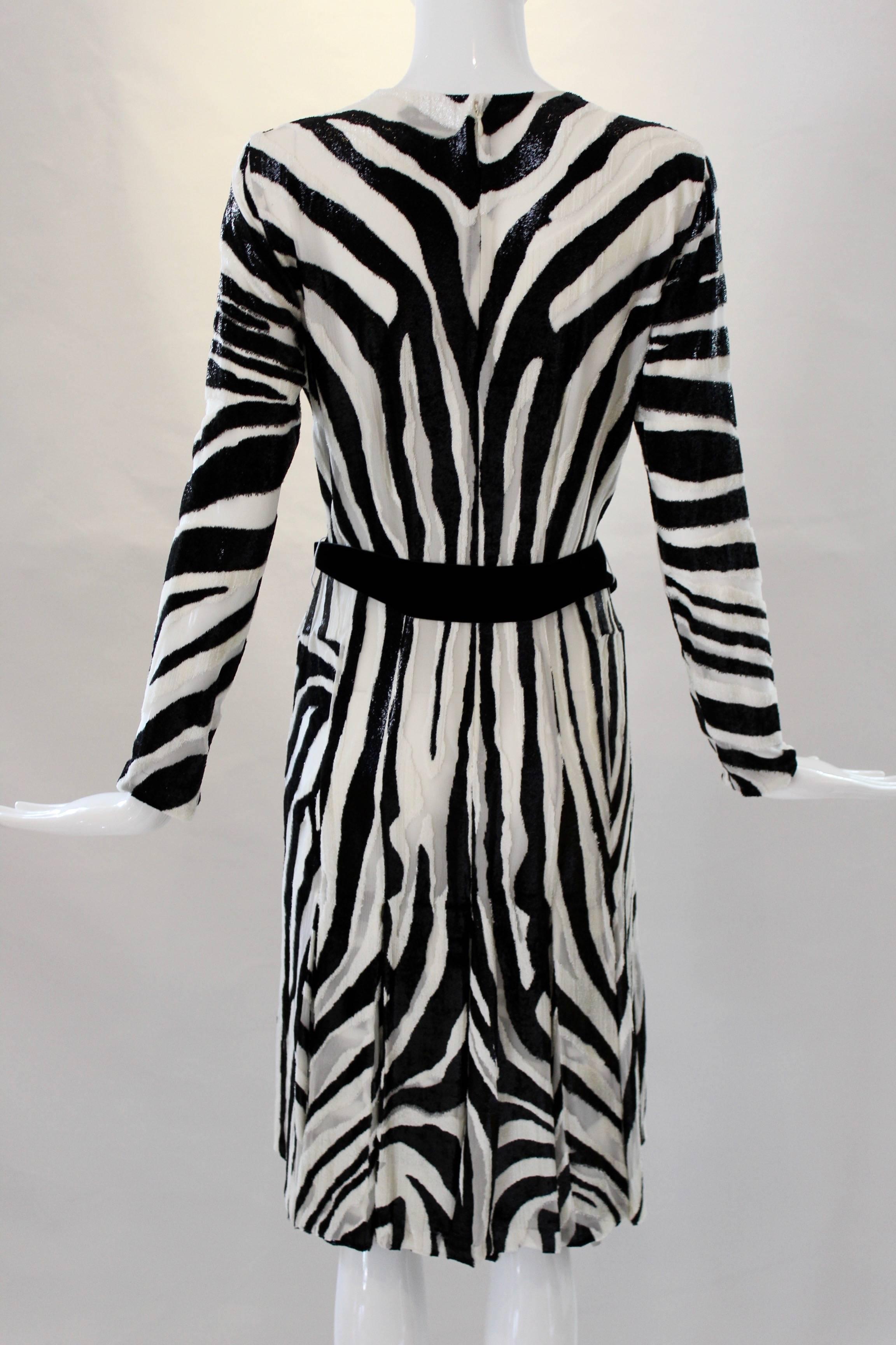Channel your inner party animal in this stunning Tom Ford number! This zebra print textured tinsel dress has three-quarter length sleeves and comes in an A-line silhouette. With a scoop neckline and zip closure, this party dress is finished with a