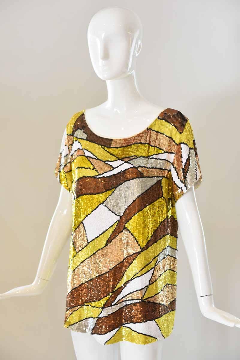 Stunning to dress both up and down, this Emilio Pucci Sequin top boasts silver, beige, brown and gold sequins throughout. With a scoop neck and short sleeves, this stand-out top is a stunner! 

Length: 26"

Bust: 38" 

Hidden zipper