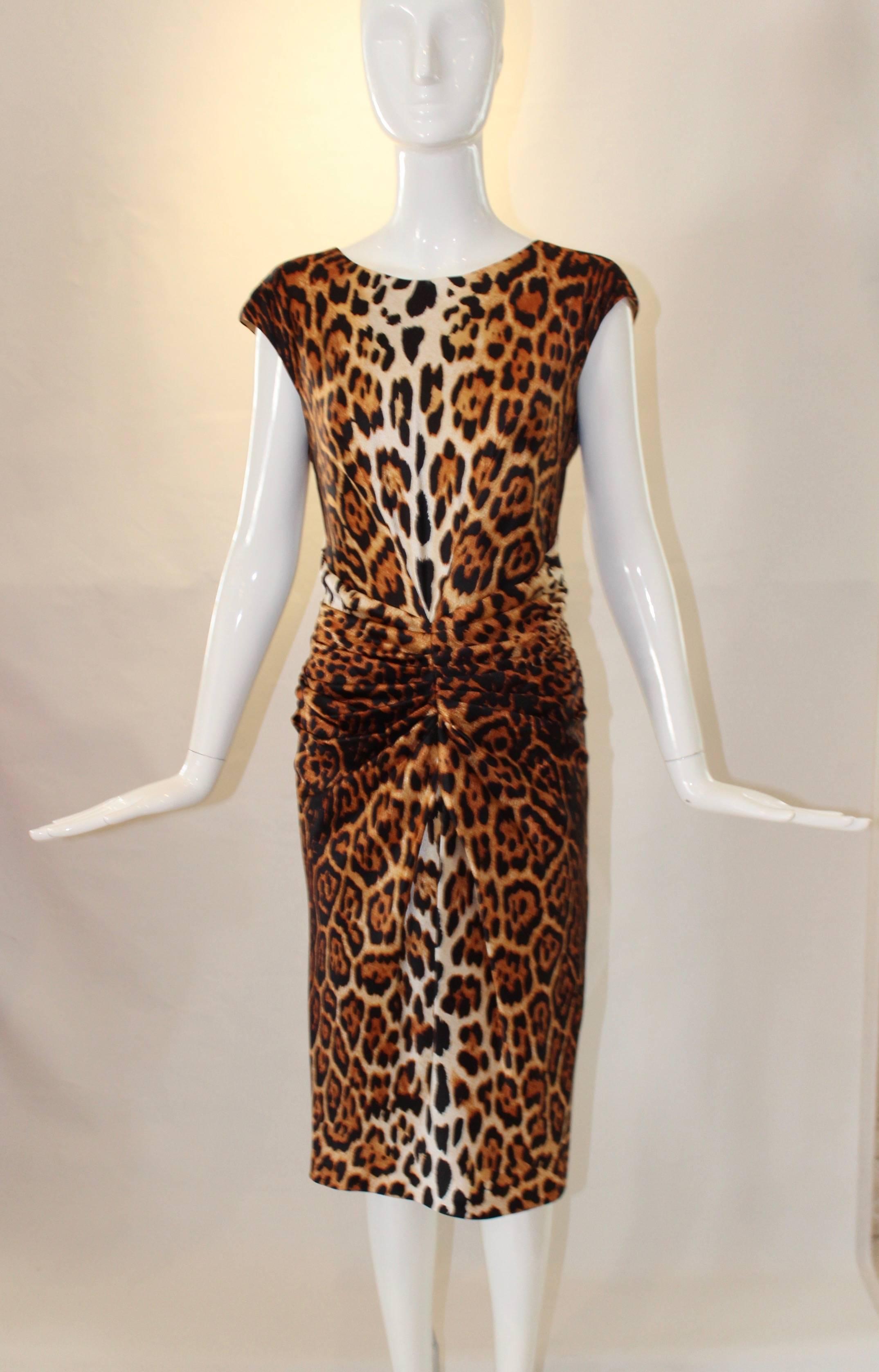 Bring out your inner wild child with this gorgeous Christian Dior Silk Leopard-Print Cocktail Dress. This sleeveless dress falls at the knee, has dramatic ruching around the waist, a scoop neckline, and a hidden zipper at the back. 

Length: