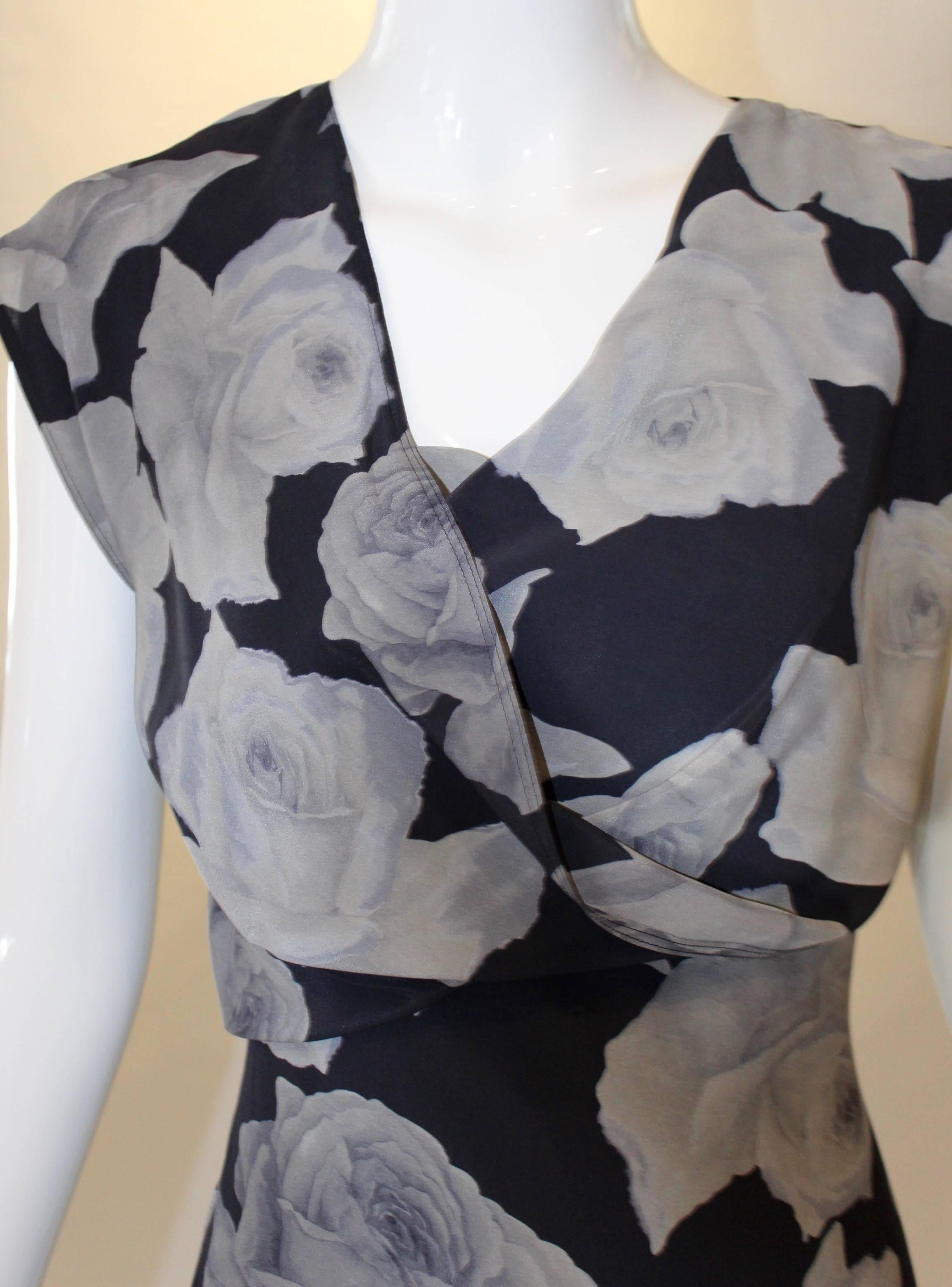 Gorgeous gray roses adorn this Lanvin Printed Silk Dress. Delicate details such as a cowl neckline and cap sleeves stand this dress apart from a crowd. From Lanvin's Ready-to-Wear Collection, this silk dress can be dressed up for both day & night.
