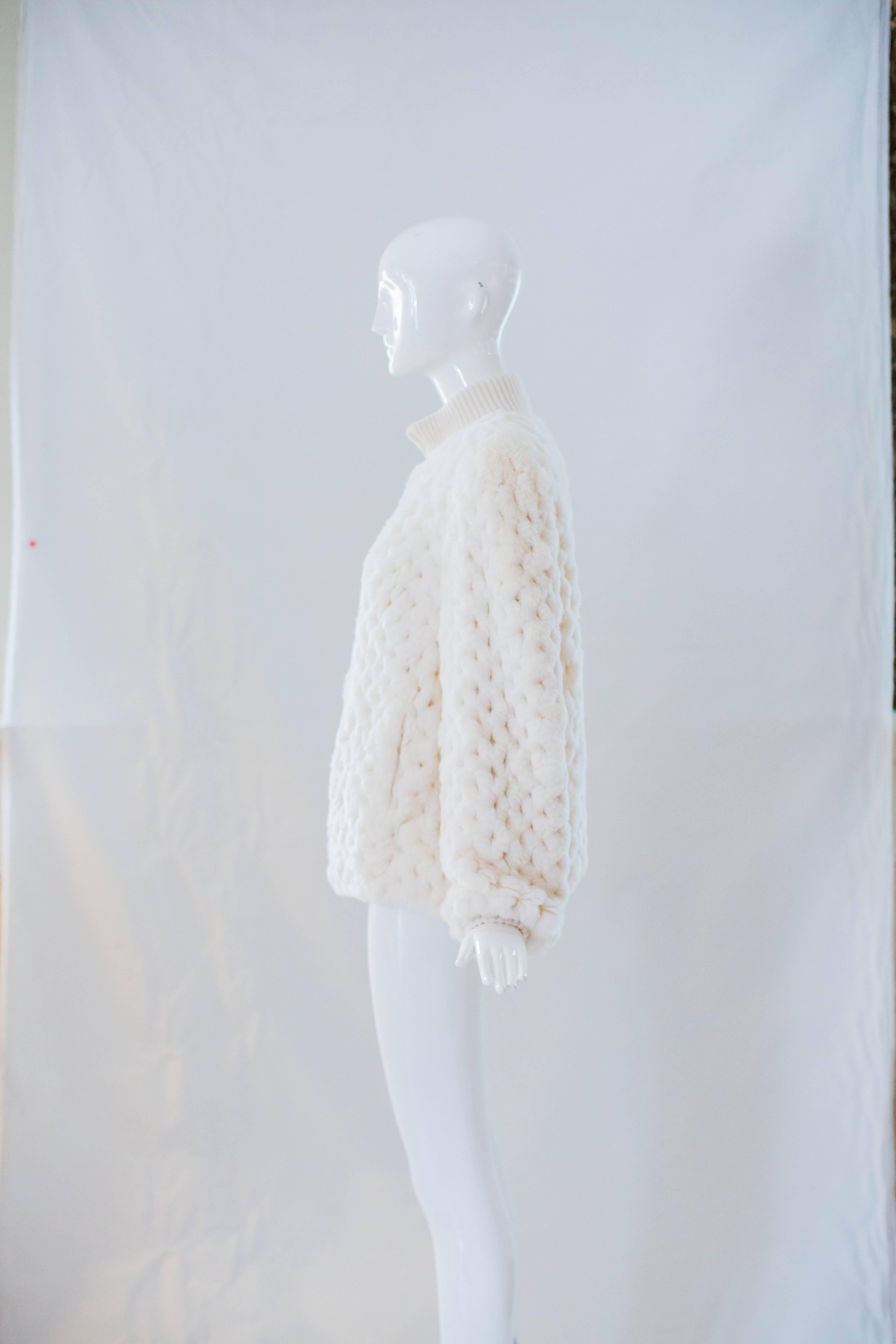 You won't believe how soft this ivory fur jacket is! Made from genuine rabbit fur that is crocheted throughout, this jacket comes in a sporty silhouette with a ribbed knit collar and cuffs with a white YKK zipper closure at the front. 

Length: