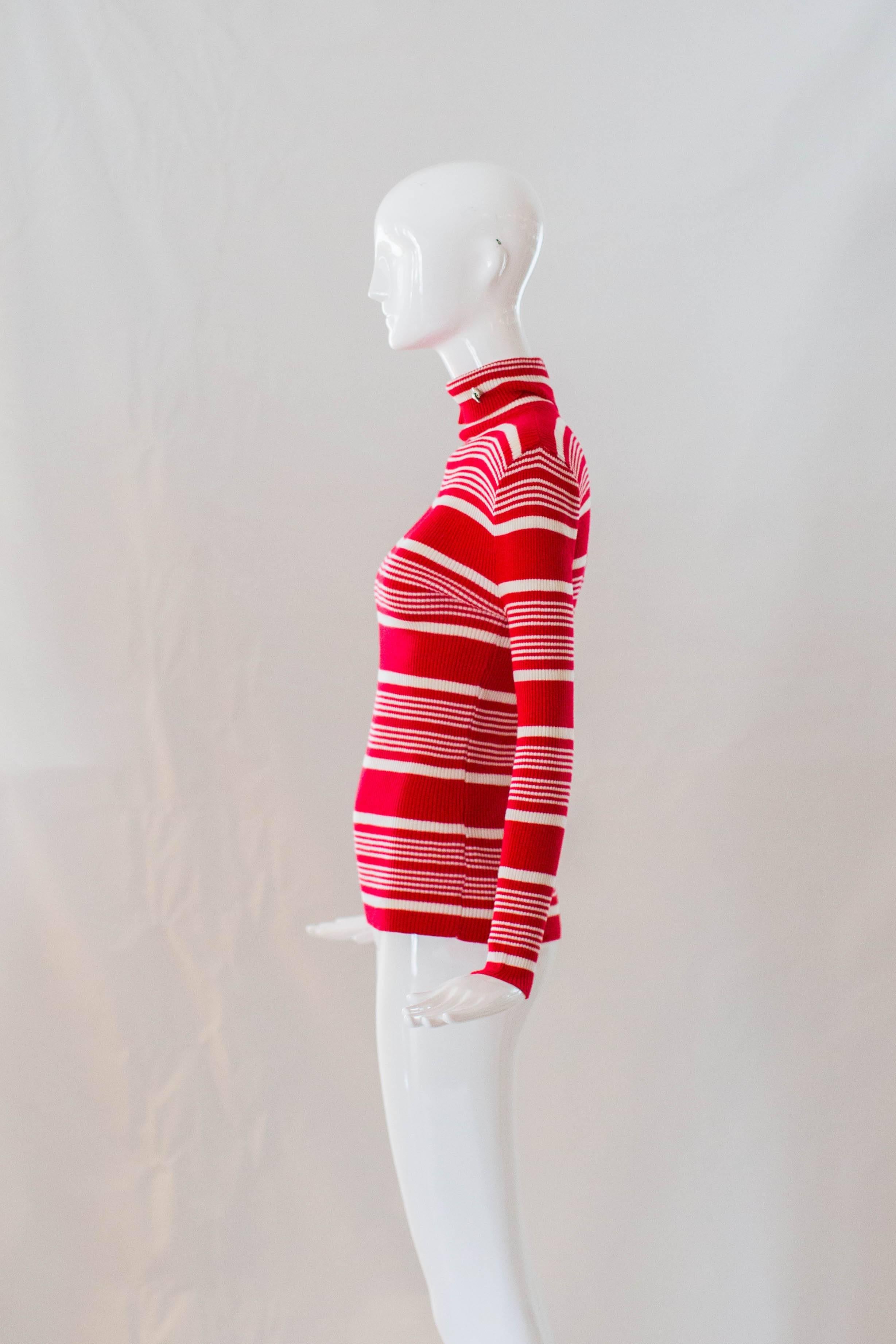 Brighten up your winter layers with a pop of color from this Pierre Cardin striped turtleneck. This comfortable ribbed knit top has long sleeves and boasts bold red and white stripes. Straight from the 1970s, this Pierre Cardin knit top is complete