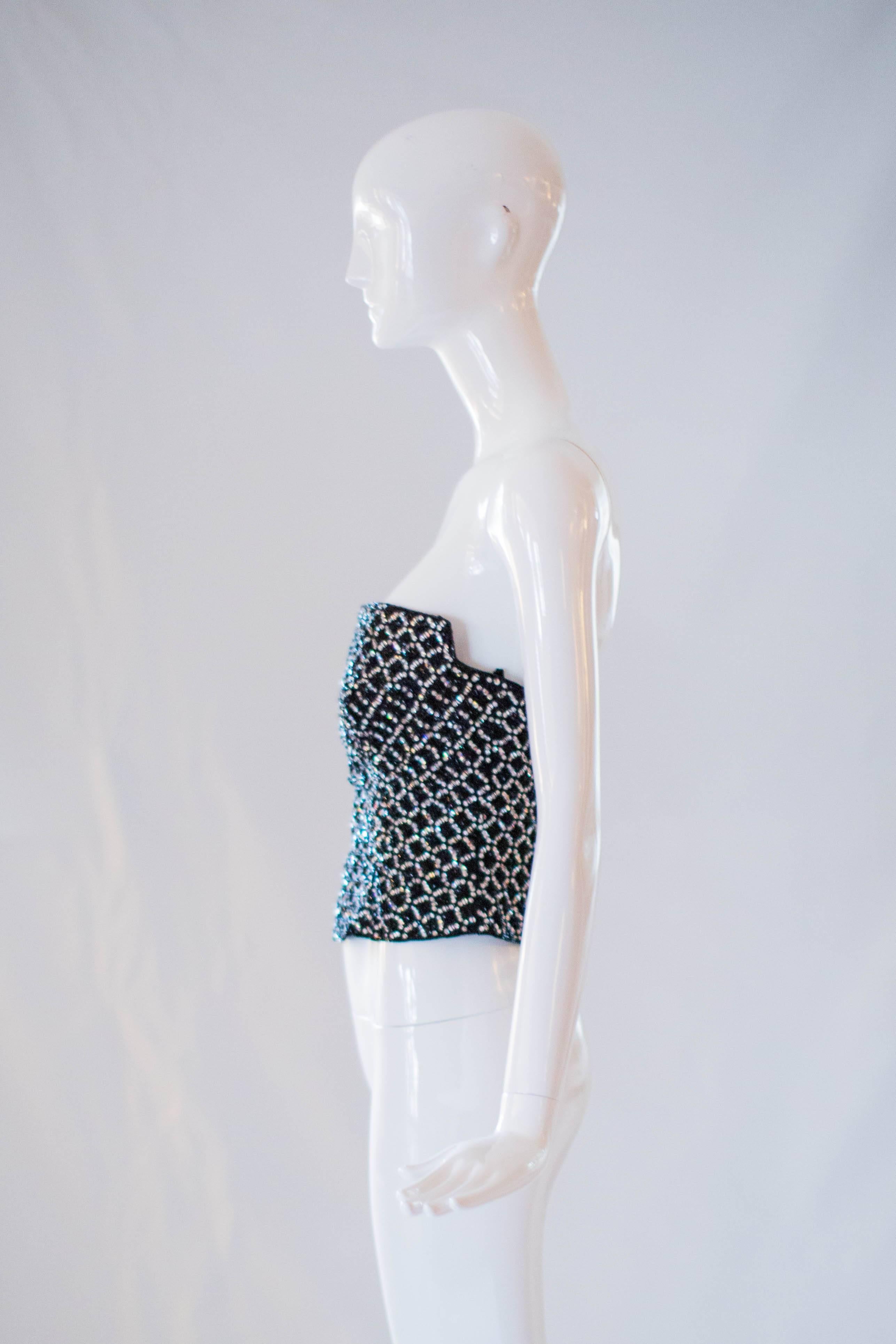 Paired with high waisted denim or a ball gown skirt, the possibilities of styling this 1990s Giorgio Armani Beaded Bustier Top are endless! Gorgeous glass beads and rhinestones adorn the front and back of this bustier top. Includes a built in bra