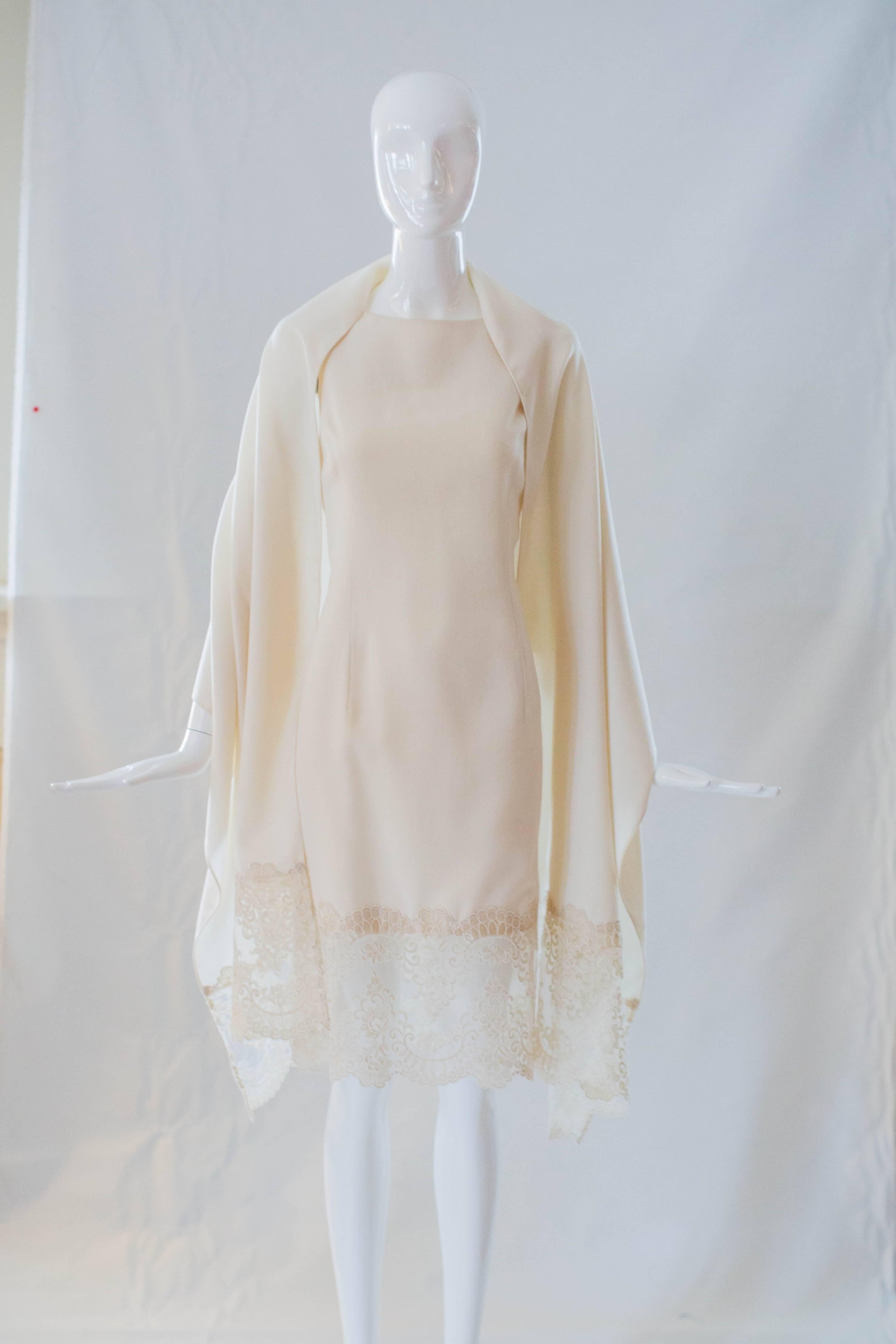 Step into spring in this timeless Amir Taghi Atelier cream lace shift dress and matching shawl. Design by young Houston designer Amir Taghi, this USA-made dress is 100% silk and features gorgeous delicate lace details at the hem. The back includes a