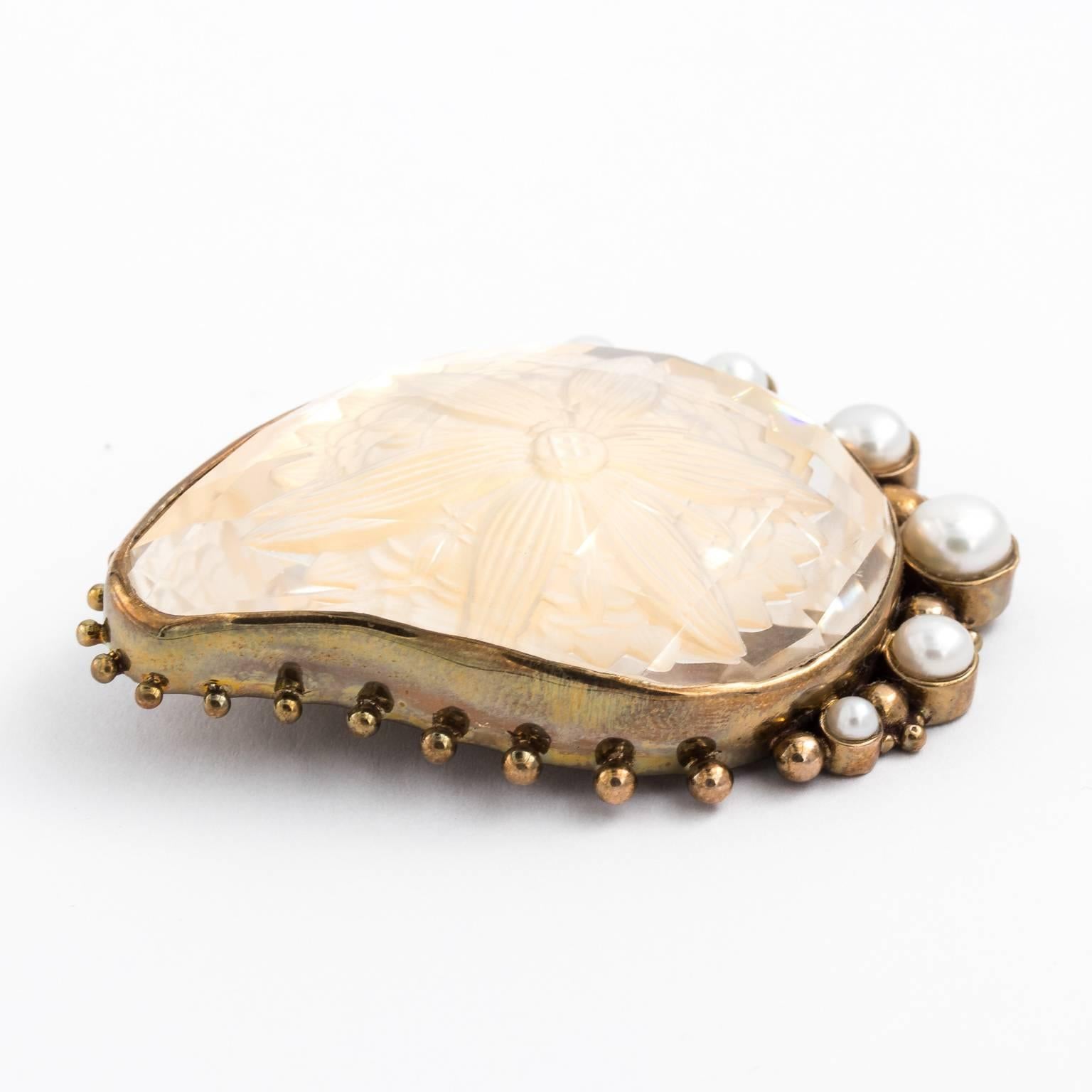 Circa 1970 Intaglio crystal and pearl brooch in a vintage bronze setting. Signed on the back by artist Stephan Dweck.