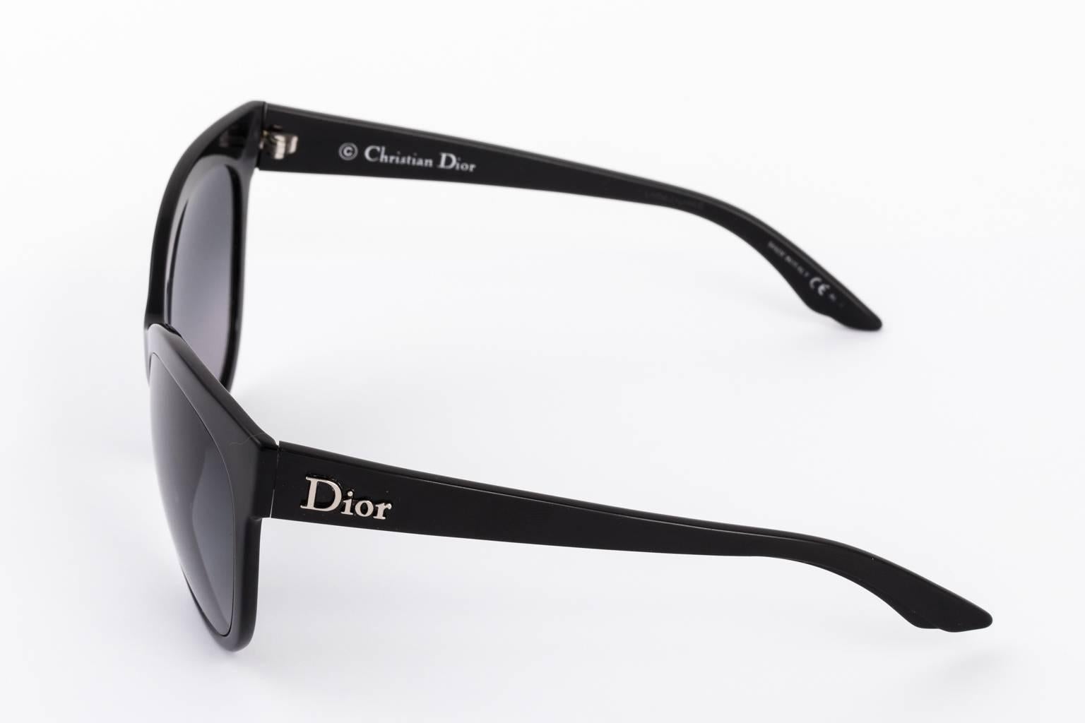 Set of contemporary large Dior sunglasses with matching case.