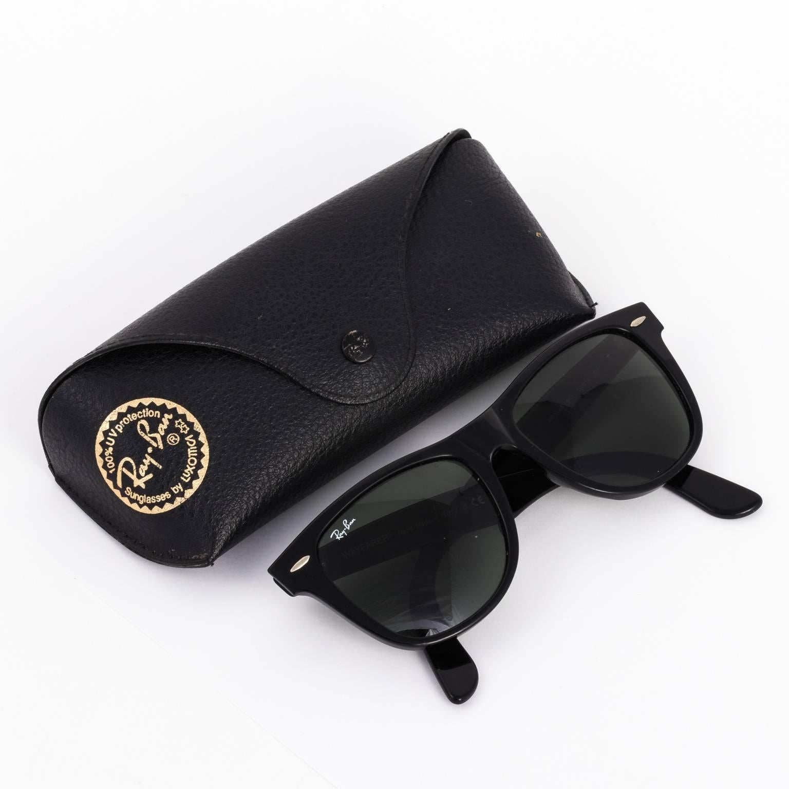 Contemporary set of black Ray-Ban sunglasses with matching soft leather case.
