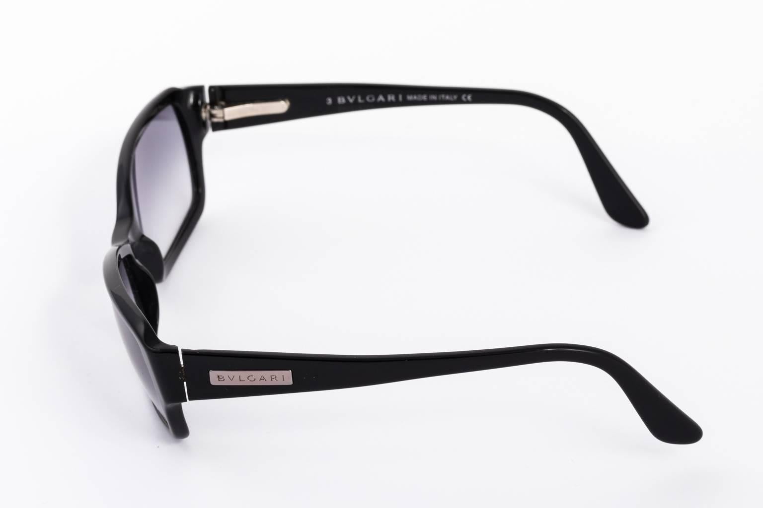 Contemporary black Bulgari sunglasses with purple tinted lenses.