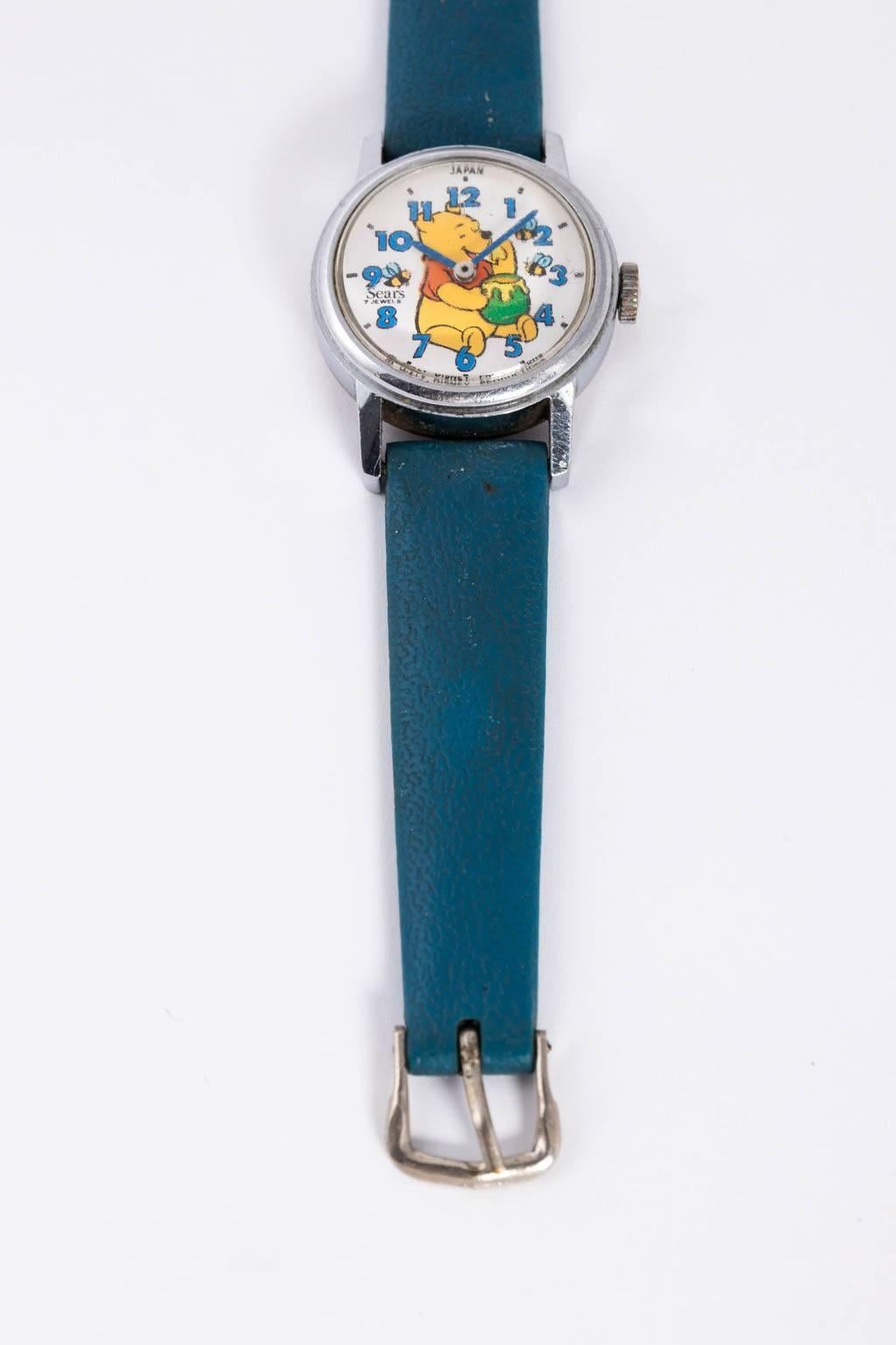 Circa 1960-1970 pair of rare vintage Winnie the Pooh mechanical watches by Sears. Windable with original blue leather arm bands. The copyright reads 