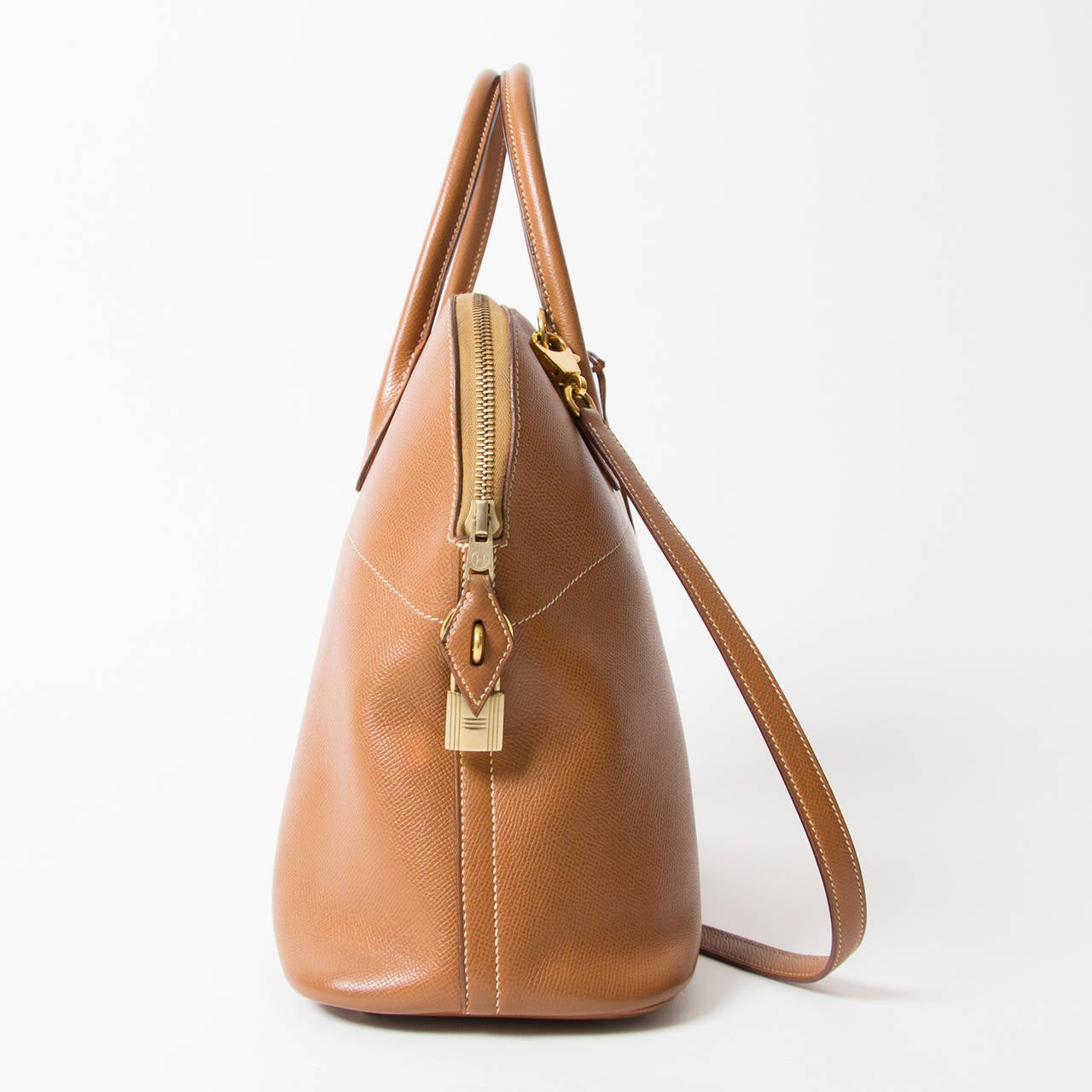 Emile-Maurice Hermès created this handbag for his wife that will be used for an automobile event in Paris. This is the first handbag to ever use a zipper. It is a domed top handle bag with a zip around closure. It also includes a removable leather