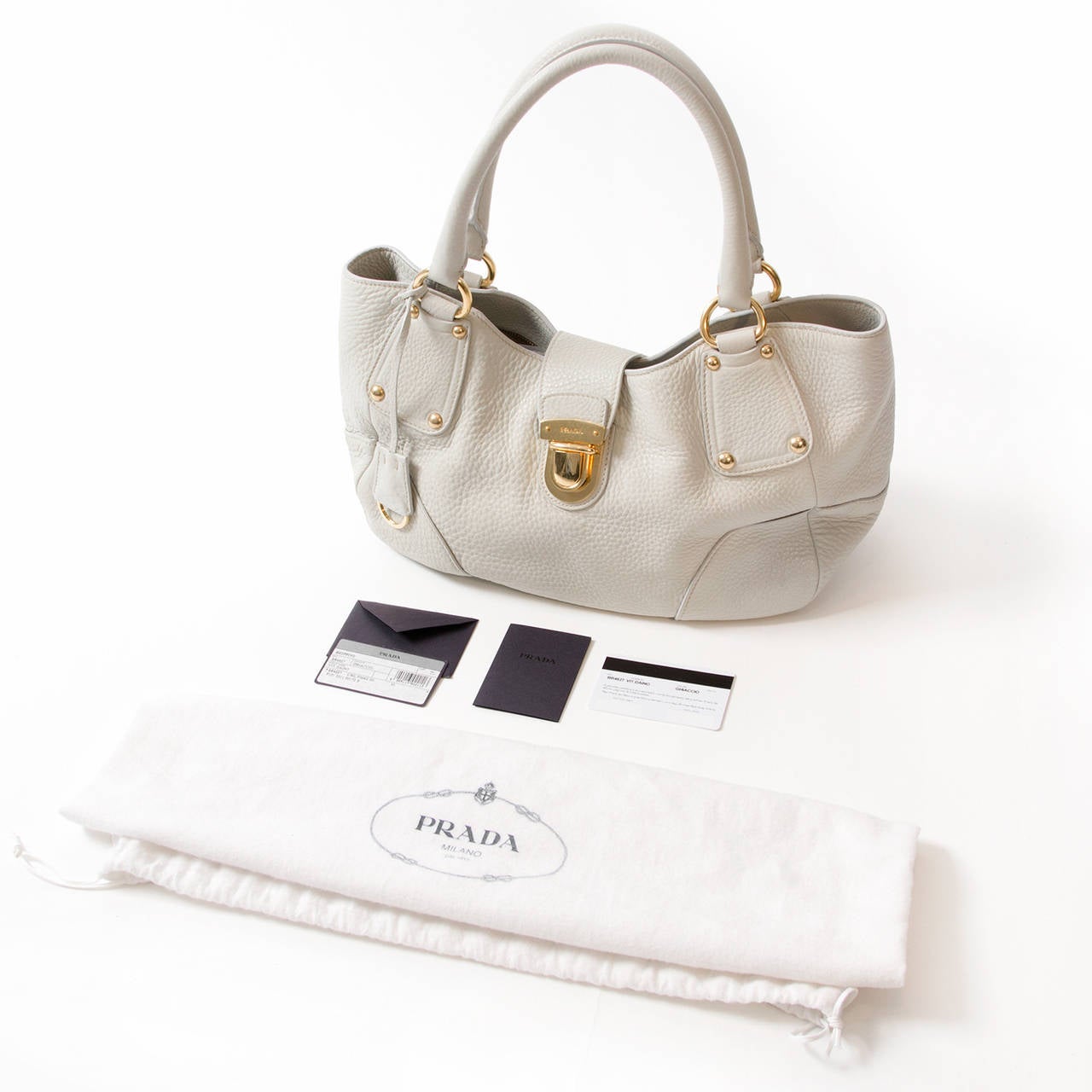 Prada Off White Shopping diano top handle bag with golden hardware. 
Clasp closure. Comes with authenticity cards.