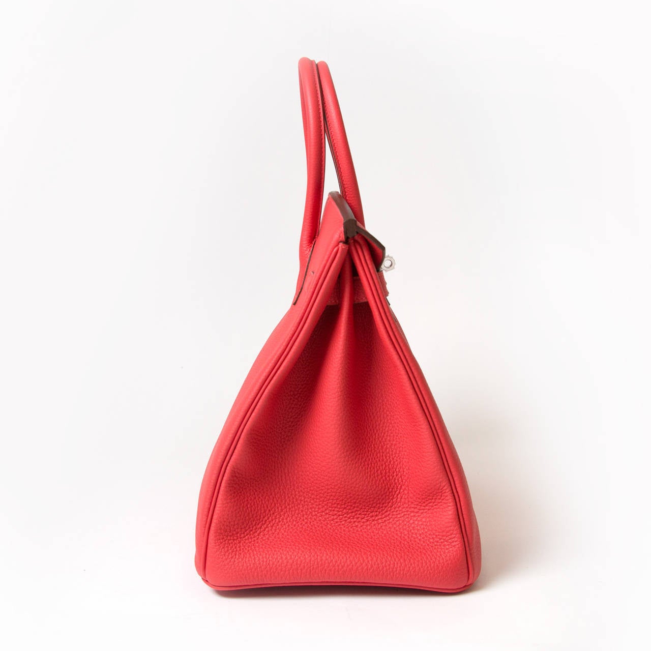 Brand New Hermès Rouge Pivoine Togo Leather 35 cm Birkin, never worn. 
This particular Birkin is in the newest shade of red from Hermès; a vibrant red  known as Rouge Pivoine.
The protective plastic is intact on all the hardware. 
Comes with