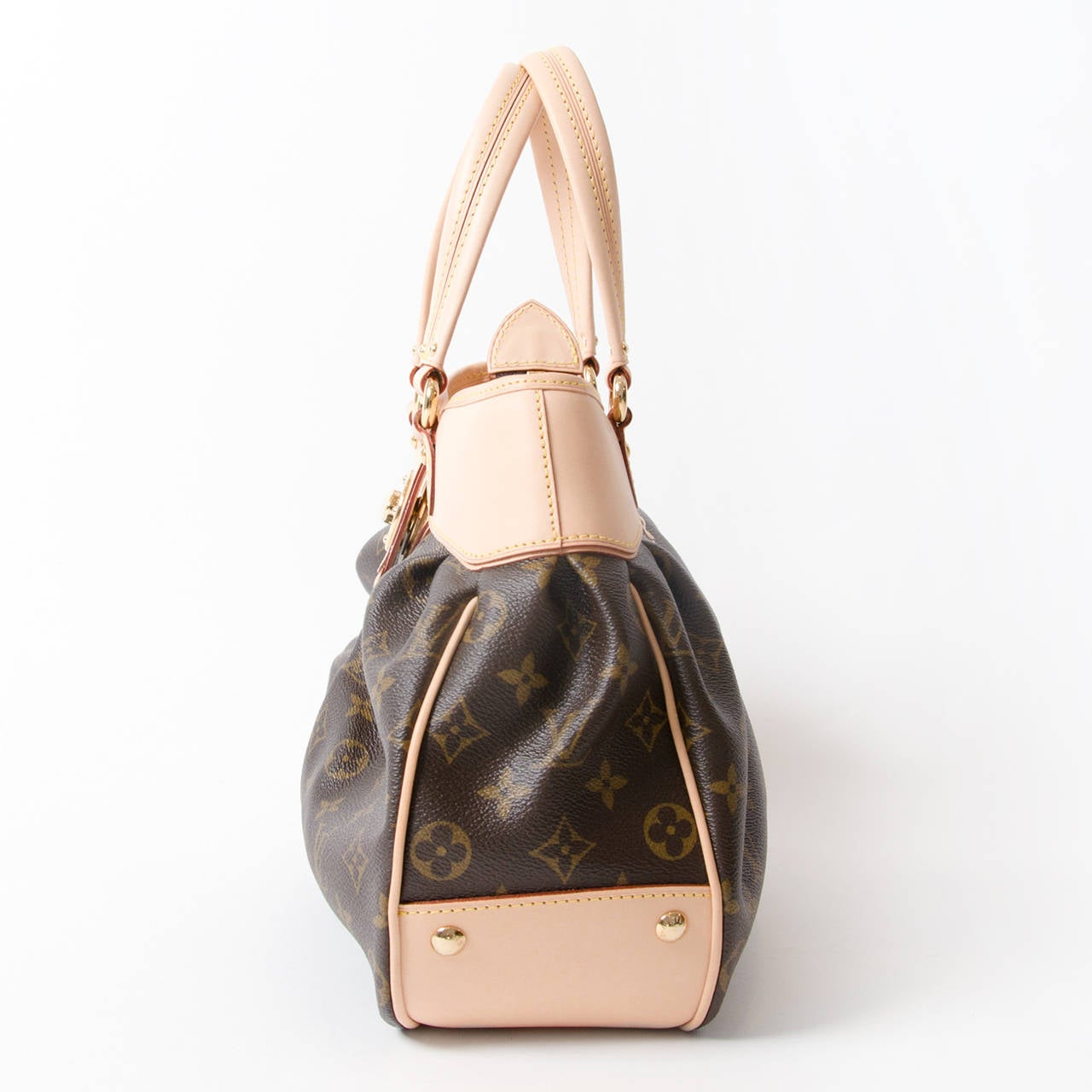 The Louis Vuitton Monogram Canvas Boetie PM is an elegant and practical bag. This bag has a feminine flair with its pleated details and engraved twist-lock closure. Golden brass studs are found on the bag's bottom side to protect from surface