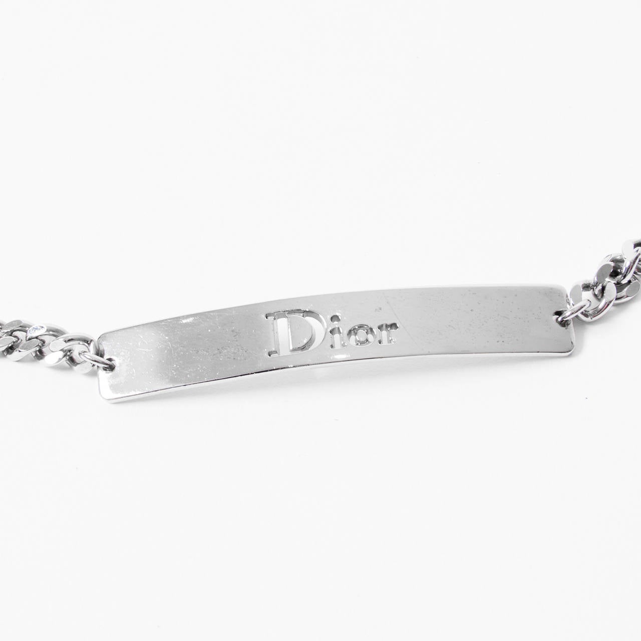 Dior laqué leather and chain belt featuring a detailed strass closure.