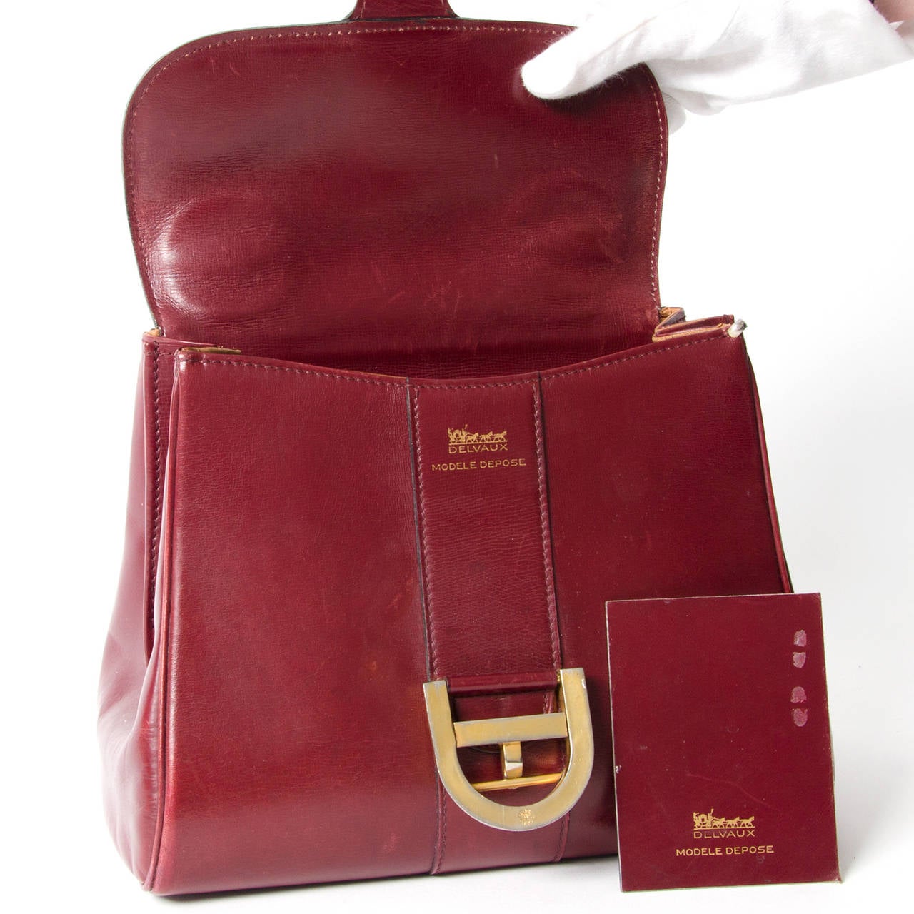 Delvaux Brillant Bordeaux PM with gold hardware in a gorgeous bordeaux red leather material. This classic satchel from premium Belgium luxury leather goods brand Delvaux excels in both style and quality. Top handle for comfortable and elegant use.