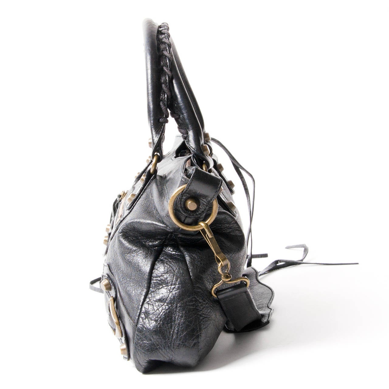 Balenciaga Nero (black) Classic First bag styled with aged brasstone hardware.
Zip pocket and metal buckles and studs at front Lined with fabric; zip pocket at interior.