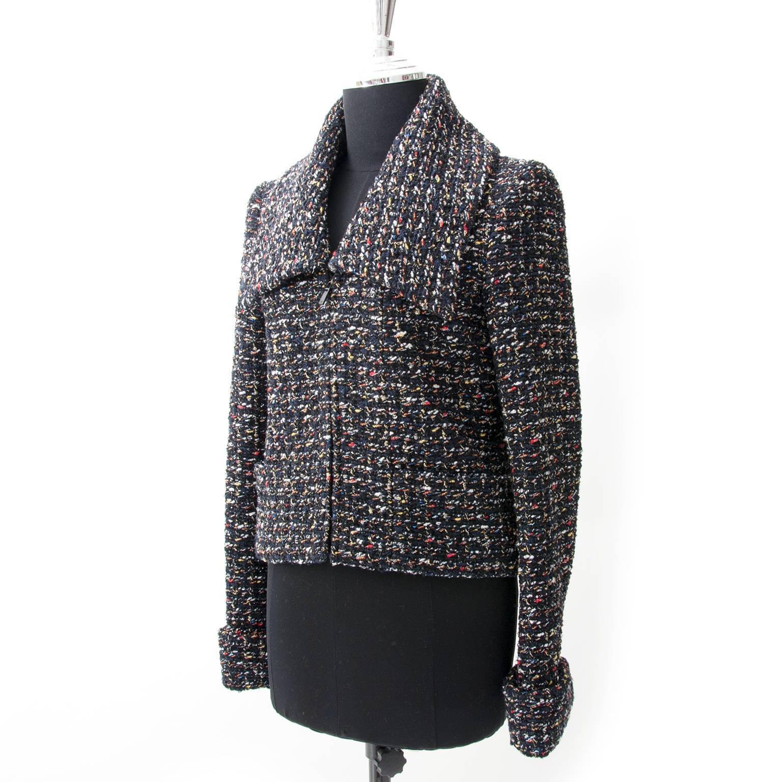 Timeless Chanel Dark blue , red and yellow vest in tweed wool. 
The classic fitted cut of this jacket makes this timeless piece the perfect item to match your entire wardrobe.

The jacket sits at the hip for a more sporty feel and meaning it can