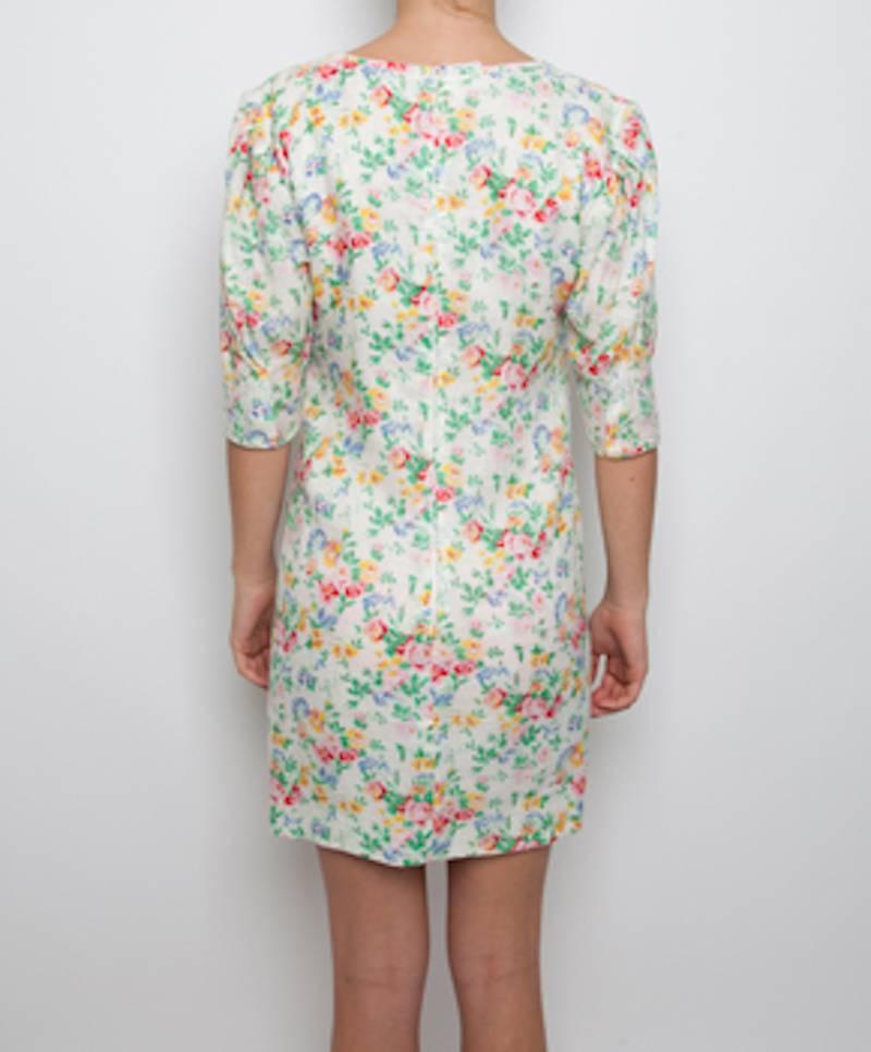 Ungaro dresses are known for their flamboyant patterns and elegant draping with an emphasis on the comfortable and flattering encasement of the female form. These dresses are truly vintage pieces. 100% white linen dress with flower print, perfect