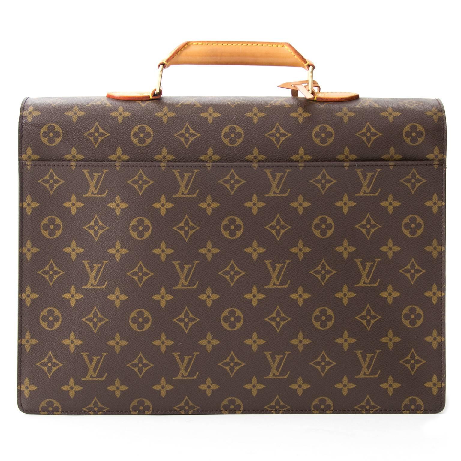 Stylish monogram briefcase by Louis Vuitton with a leather handle and gold-tone details. Extra compartment at the back. Functional interior with two large compartments keeps papers and personal items in order. Comes with a little key to lock the