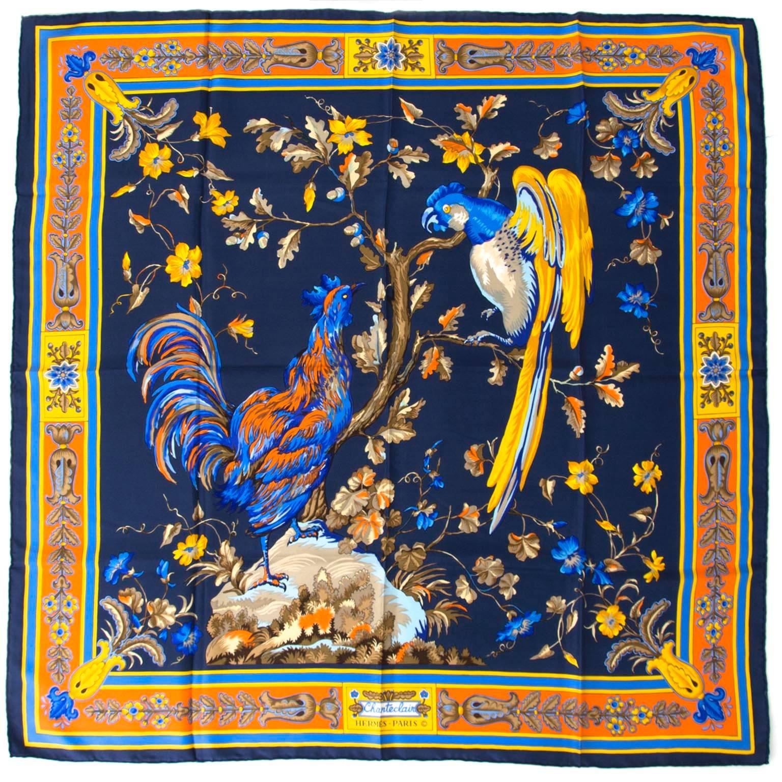 Hermès Carré De Soie scarf in dark blue and orange tones and with parrot design. 

100% silk. 