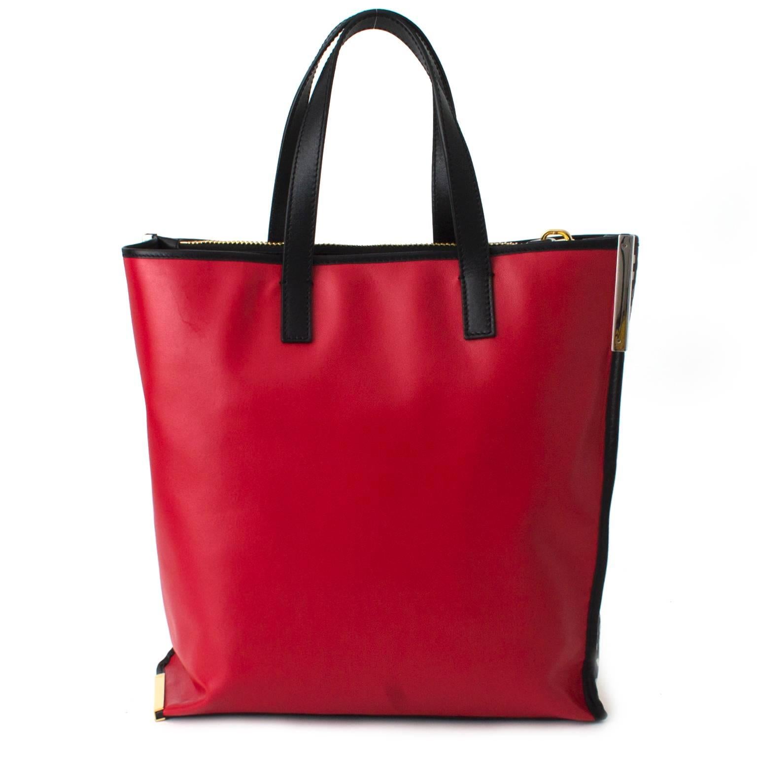 Emanuel Ungaro Black Patterned Shopper Tote.
Black, white and red calf leather  shopper tote featuring top handles, a metallic logo stamp,  one zipper department and two open departmens. 