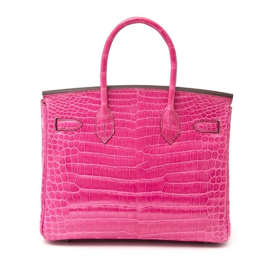 THIS RARE BIRKIN WILL TAKE YOUR BREATH AWAY! One of the most beautiful colors. Shiny Fuchsia Porosus with silver hardware . The Birkin is one of the most sought after especially in this vibrant fuchsia Porosus. 

Comes with the original box, receipt