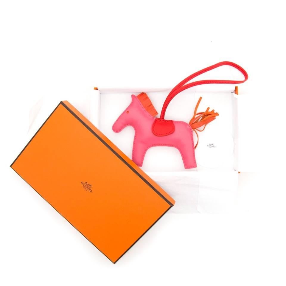 Authentic Hermès Rodeo Horse Charm Rose Azelea and Orange.  Hand-stitched horse in soft lambskin leather. Perfect for hanging on your Birkin, Kelly, Garden Party, or any other Hermes bag.

Comes with receipt and box.