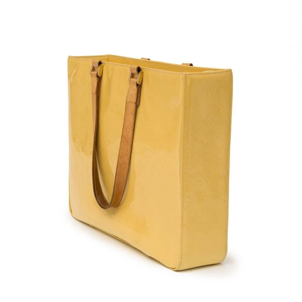 Llarge, flashy and practical Louis Vuitton tote.
This Yellow Louis Vuitton SMonogram Vernis Columbus Tote is great for fashionistas on-the-go.
Its large size will hold just about anything and the patent Vernis finish looks great while resisting