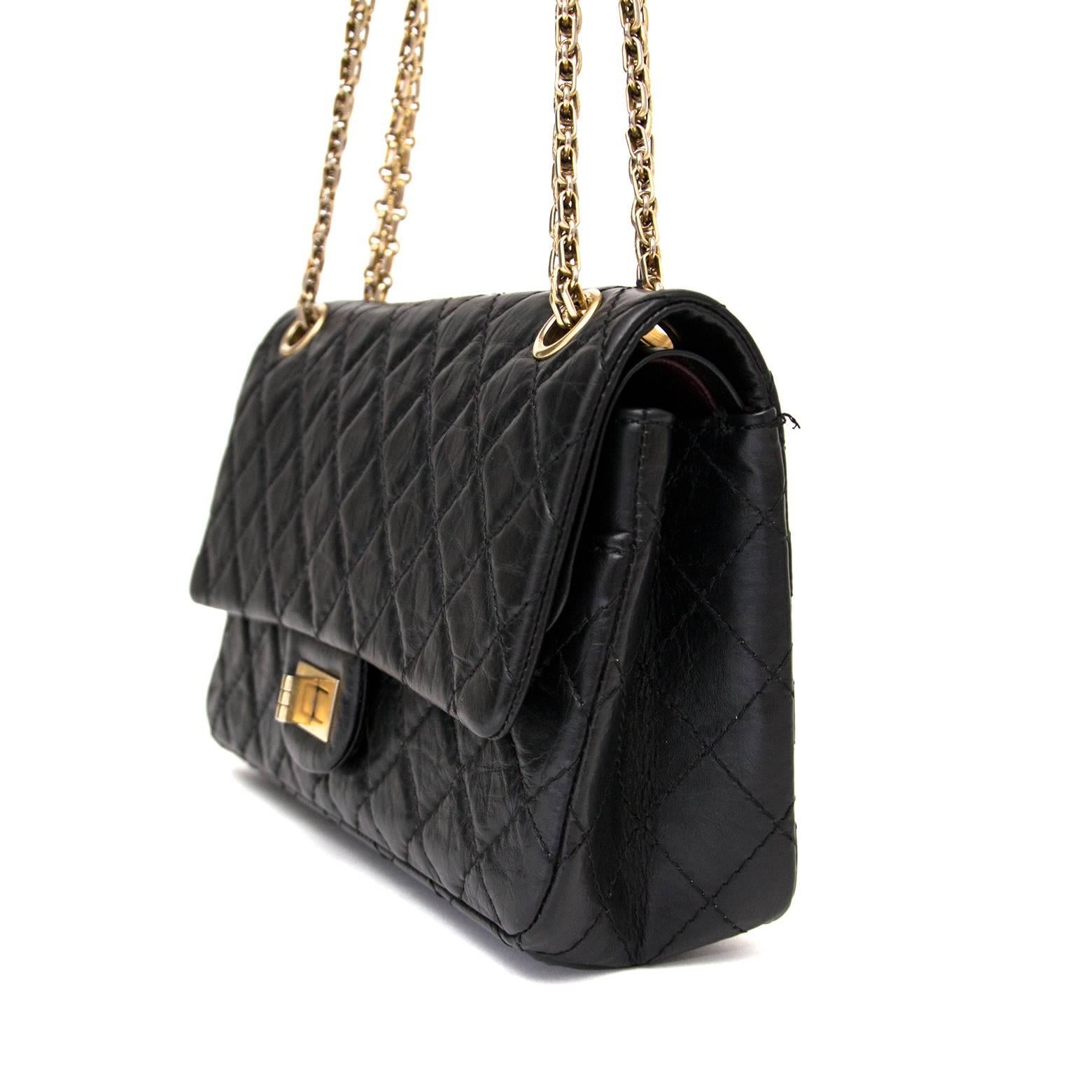 This charming Chanel 2.55 reissue bag comes in classic black with gold hardware. This is a true classic investment piece and a must for every woman. The bag is just large enough for all your essentials. This beautiful bag showcases signature