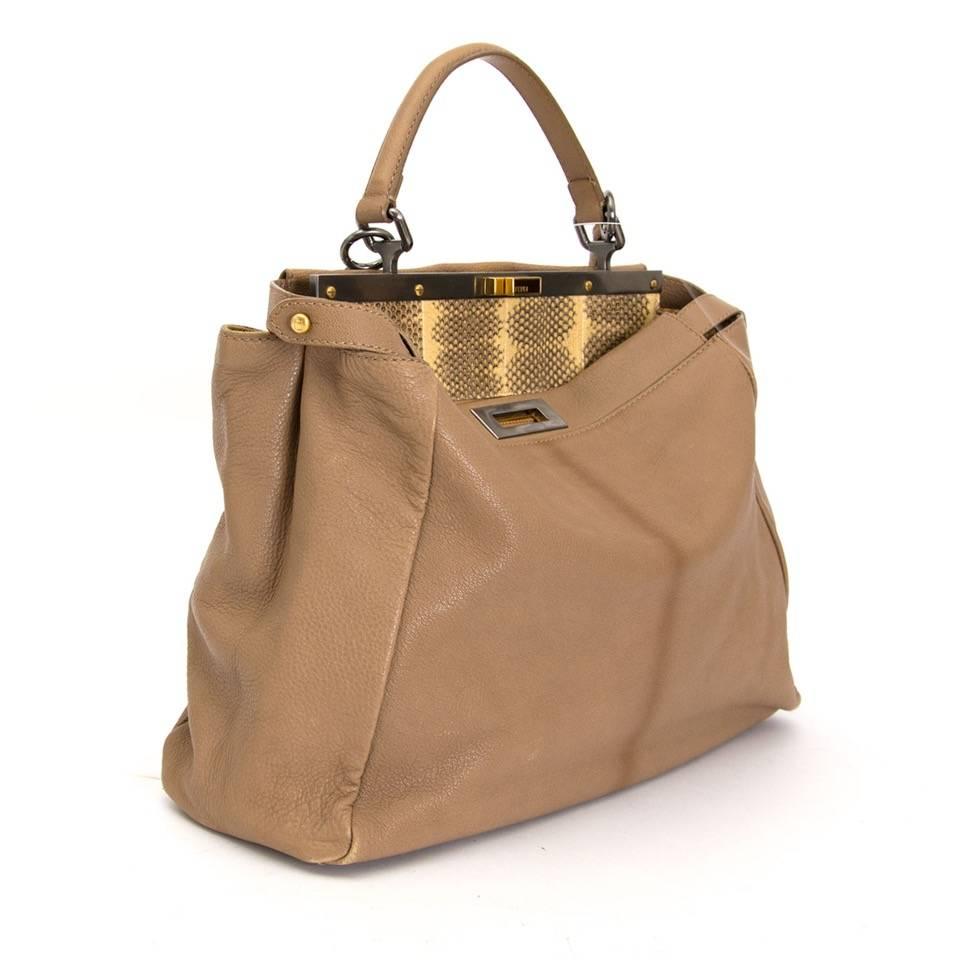 Fendi ombre sand color Peekaboo Handbag w/ Python Interior on one side and beige suede on the other side.

Gunmetal-tone and polished goldtone cutout turn locks.
This exclusive bag has been seen on some of our favorite celebs like Sarah Jessica