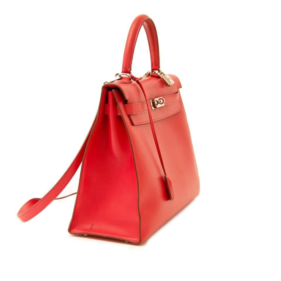 Hermes Kelly Sellier 35 Bougainvillea Swift PHW.
Beautiful  vibrant Bougainville color is a coral slight pinkish red.
The Kelly Sellier, or “rigid” Kelly has a boxy, structured look. The bag is made out of swift leather, this type of brilliant