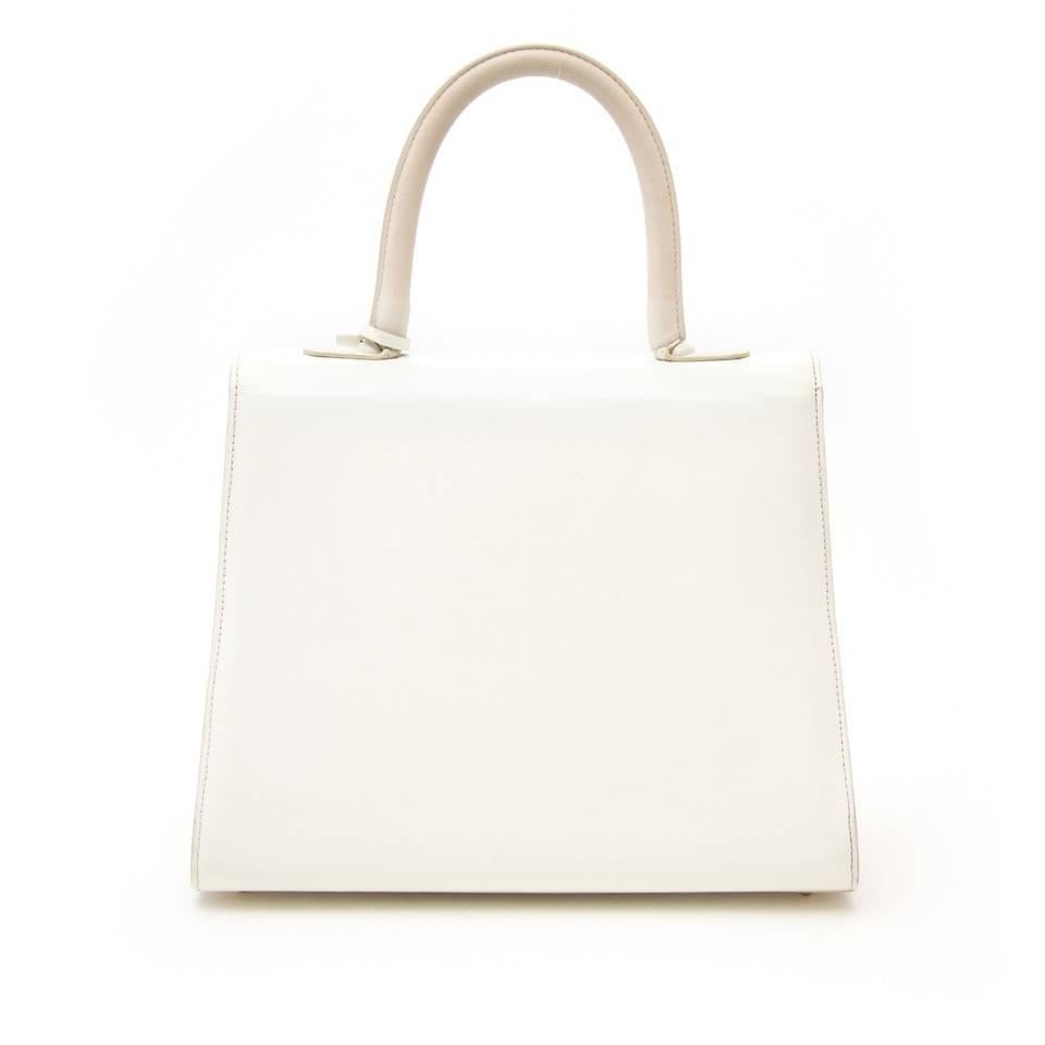 Delvaux Brillant MM with gold hardware in bicolor in two shades of snow white featuring two different types of leather.

This classic satchel from premium Belgium luxury leather goods House Delvaux excels in both style and quality.

Top handle