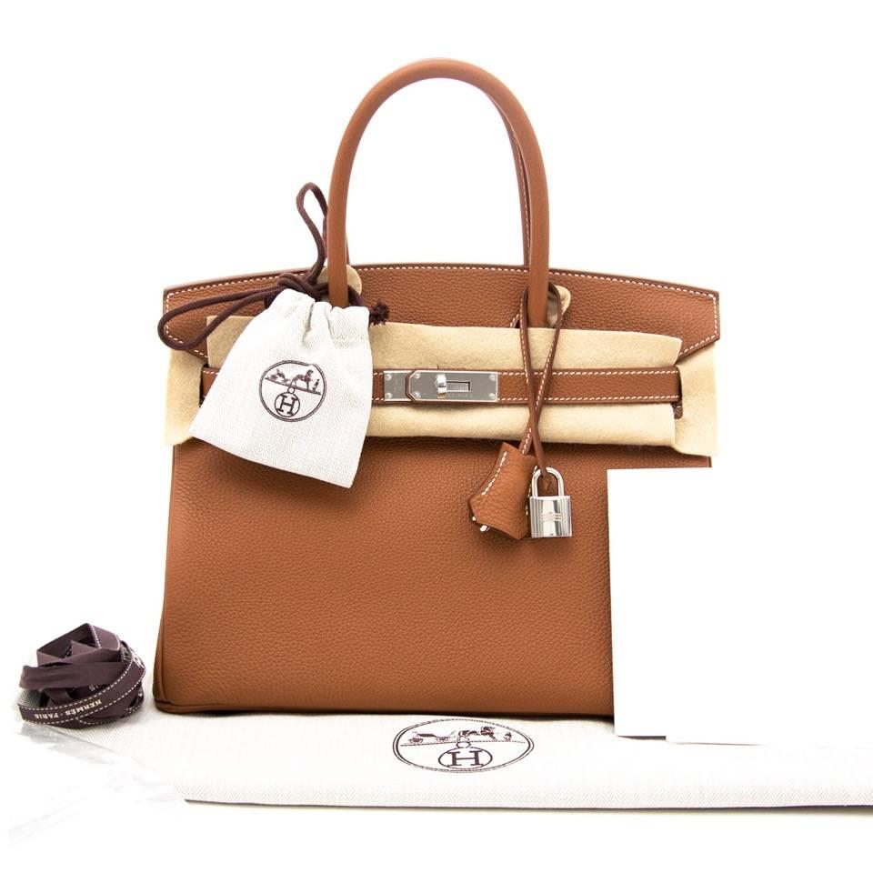 Skip the waiting list and get your hands on the most iconic bag of all time: the Hermès Birkin.
This Hermès Birkin in veau togo comes in a gorgeous neutral gold color and features striking palladium toned hardware.
The size 30 exudes true