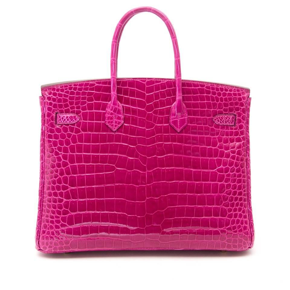 This Rare Hermes Birkin 35cm Rose Sheherazade Porosus Lisse  bag is accentuated with palladium hardware and comes with all of the original accessories. 
 This limited Birkin bag is made from porosus crocodile skin with a brillant shine, which is