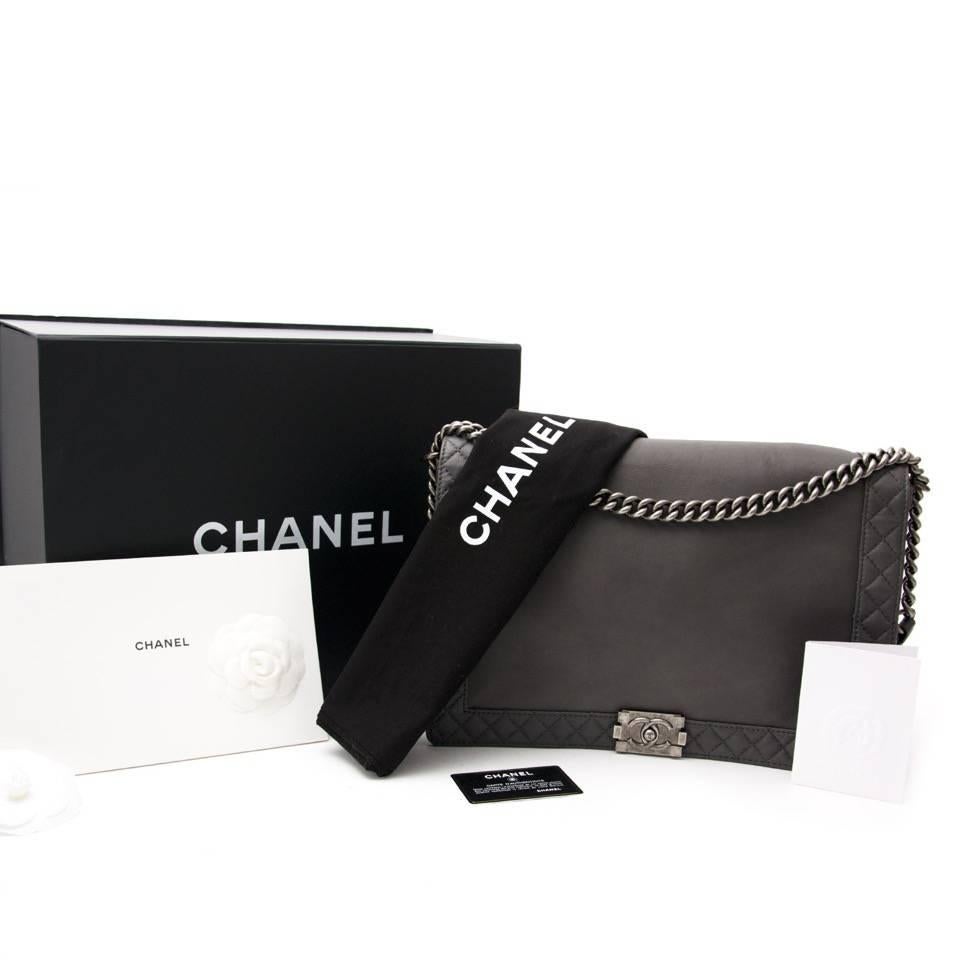 Grey Chanel Boy Reverso Medium Flap Bag with antiqued silver-tone hardware, 3 interior compartments, interior zipped wall pocket, two interior slip pockets and front flap interlocking CC spring release closure. Serial number 