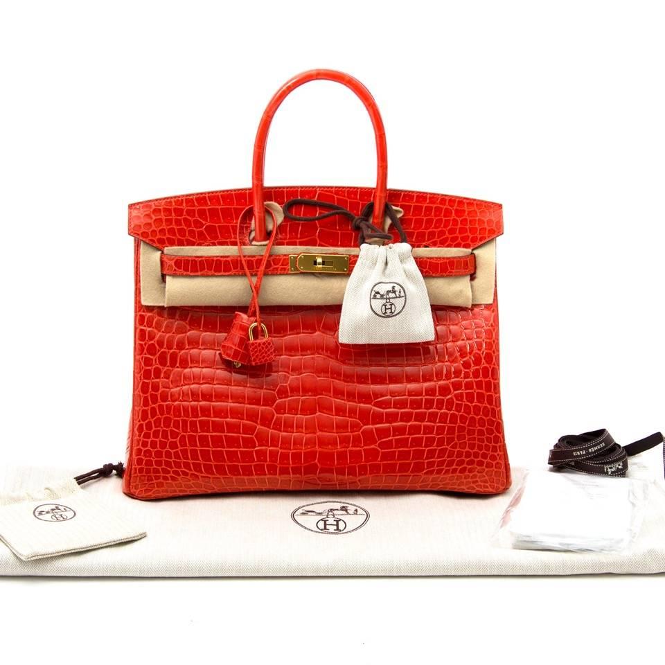 Very Rare Hermes Orange Poppy Porosus Crocodile Birkin 35.
This limited Birkin bag is made from porosus crocodile skin with a brillant shine, which is denoted by the circumflex symbol (^) in the embossing.
The lisse croc finish shows every detail