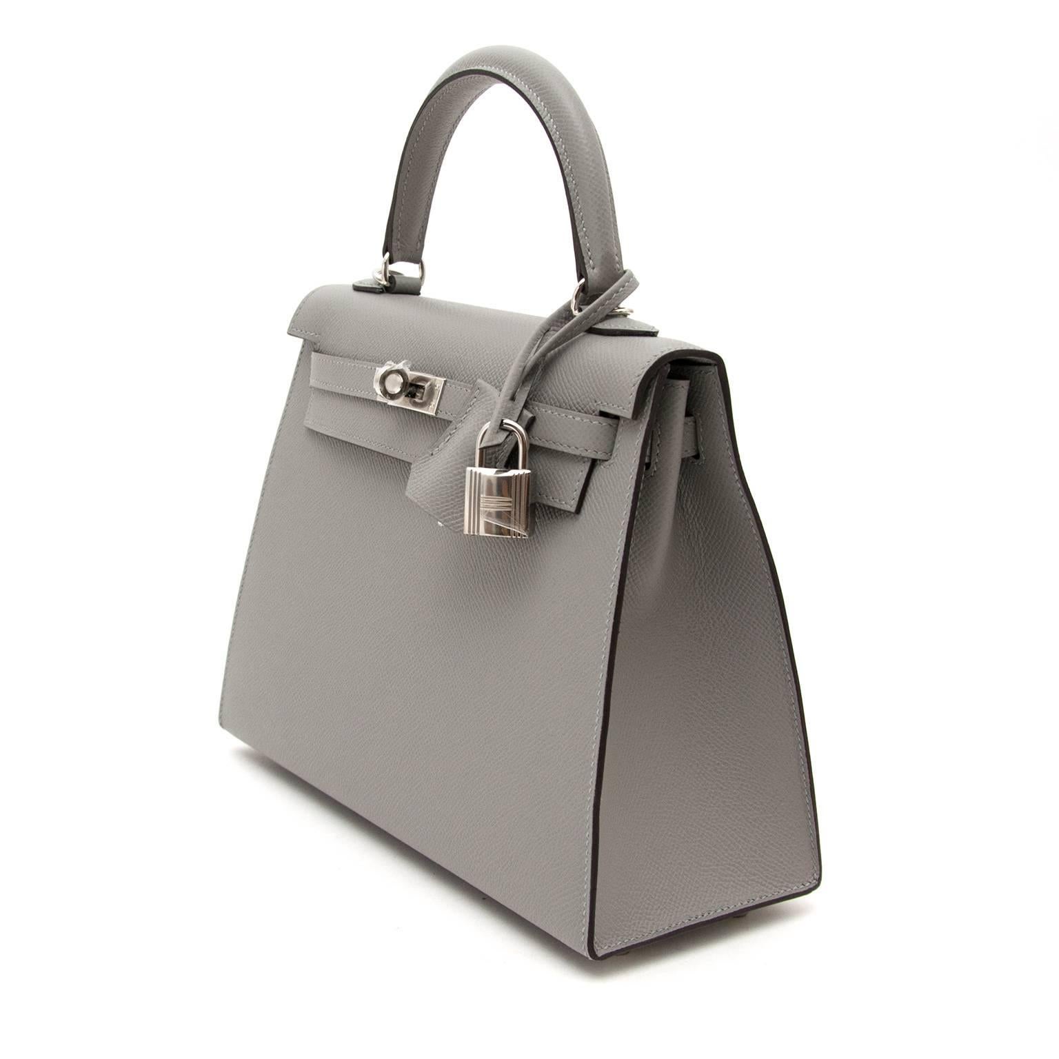 This Very Rare Brand New Hermes Kelly 25 Gris Mouette Epsom PHW is the perfect mini bag.
 Perfect for a day to night bag. Mini bags are the most desired in the marketplace.
Togo leather is A highly popular leather because it does not scratch