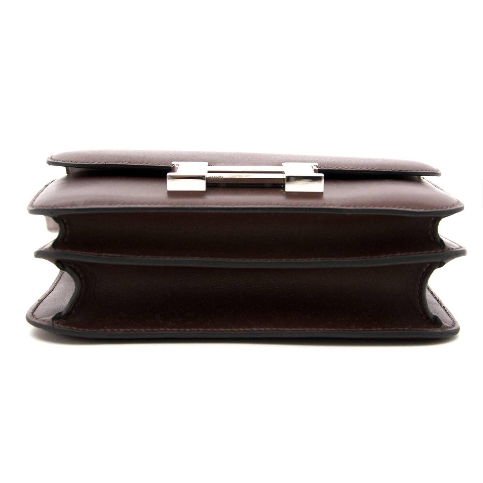 
This little gem is the Hermès Mini Constance III in super soft butler leather in timeless 'Moka',  very dark brown with slight hint of purple undertones .
The silver-tone H closure gives it a more mature, feminine touch.

The Constance is the